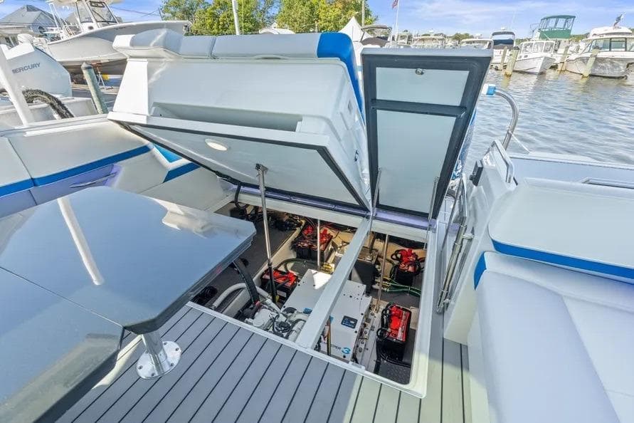2024 Formula 380 Super Sport Crossover OB engine compartment, open hatch, docked at marina.