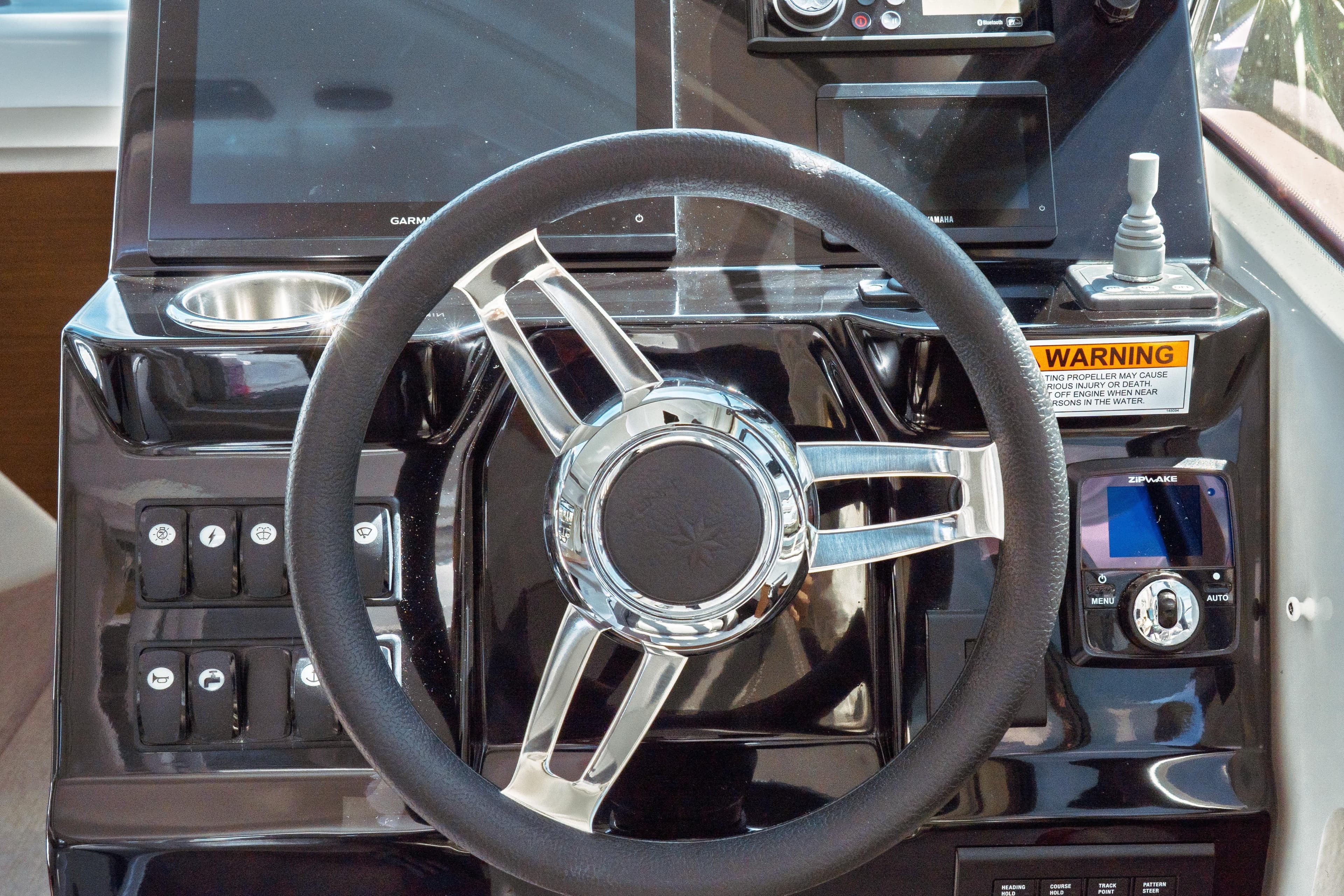 Steering wheel and dashboard of 2023 Jeanneau NC Weekender 795 Series 2 boat.