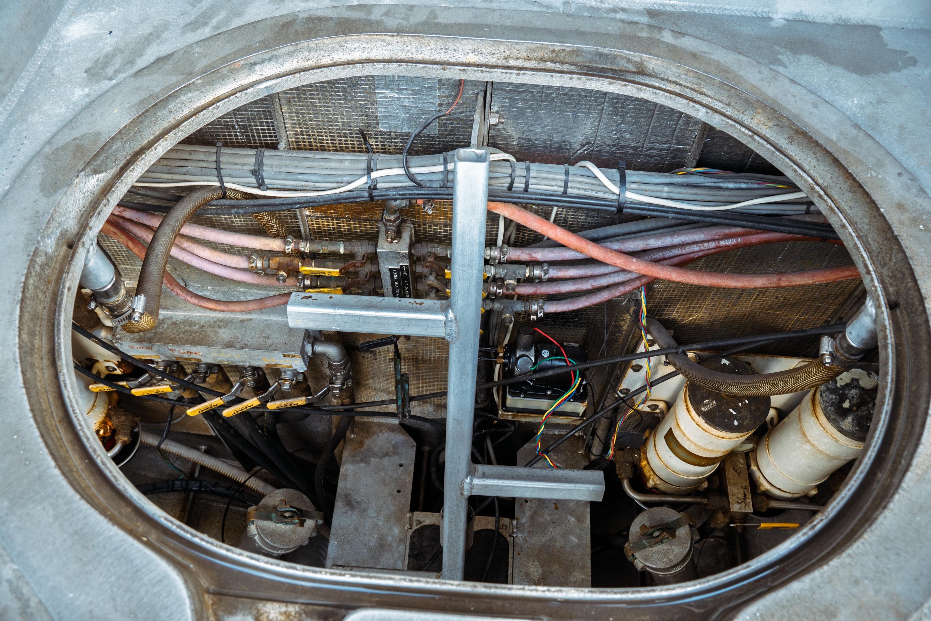 Engine compartment of a 2004 Kvichak Marine Industries Pilot boat, showing cables and hoses.