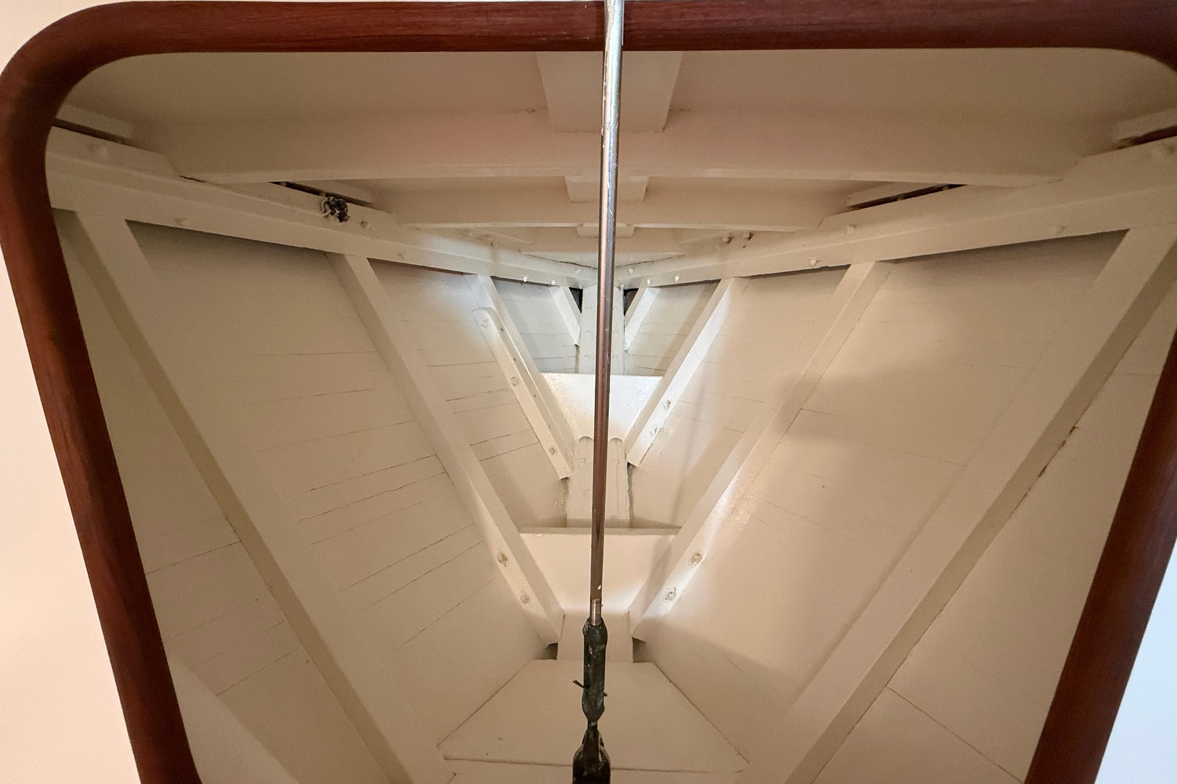 Interior view of a 1962 Lapworth Sloop sailboat, showcasing wooden structure and rigging.