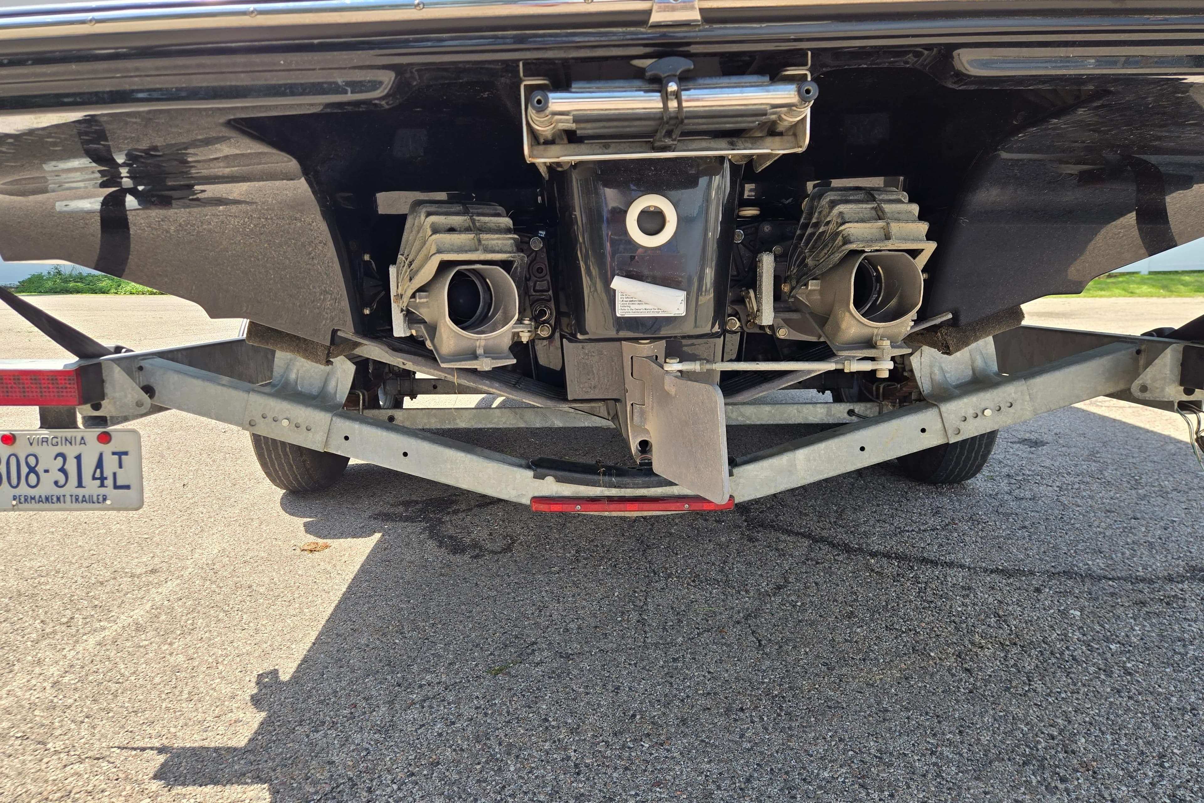 Rear view of a 2018 Yamaha Boats 242X on a trailer.