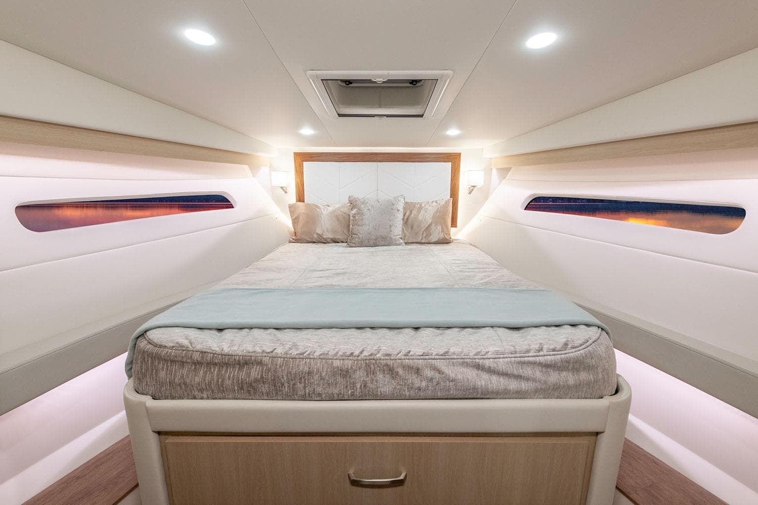 Manufacturer Provided Image: Luxurious cabin interior of 2026 Regal 38 FXO yacht with elegant bedding and ambient lighting.