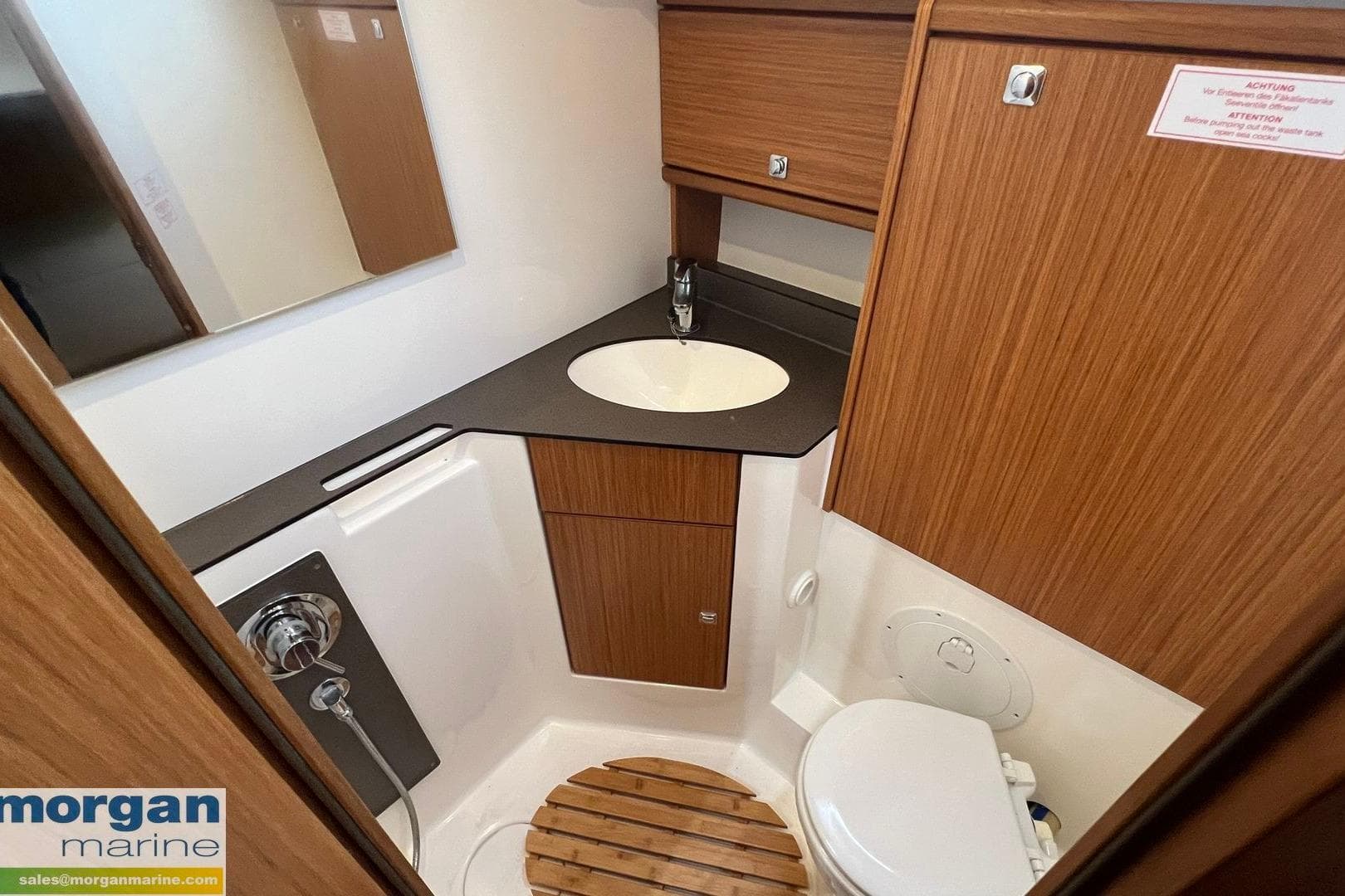 2015 Bavaria Cruiser 46 bathroom with wooden cabinetry and modern fixtures.