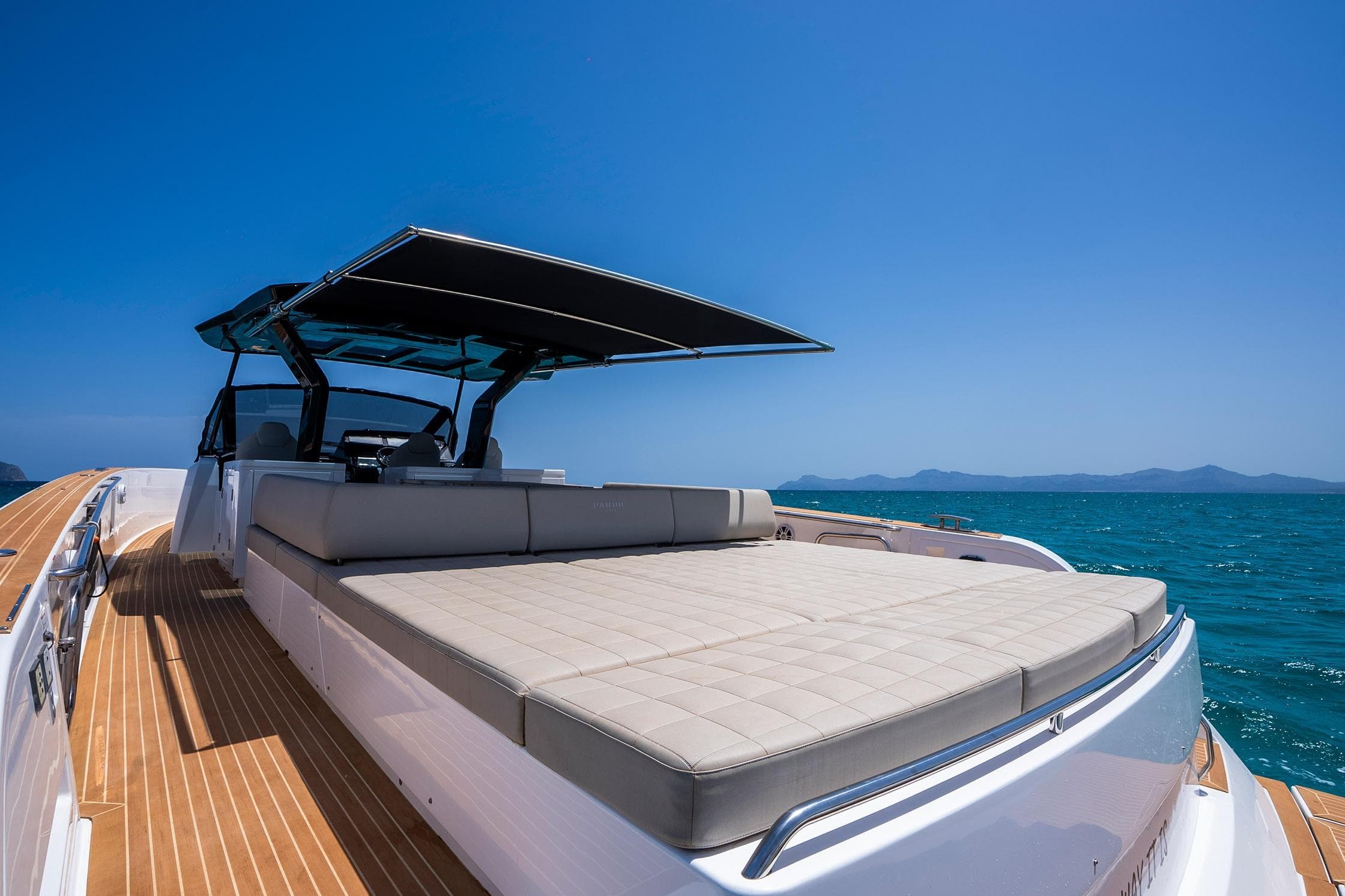 2022 Pardo Yachts 50 luxury yacht with sunbed and canopy on open sea.