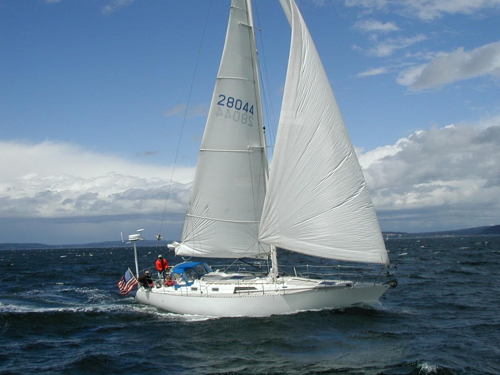 1983 Nordic 44 sailboat navigating rough seas.