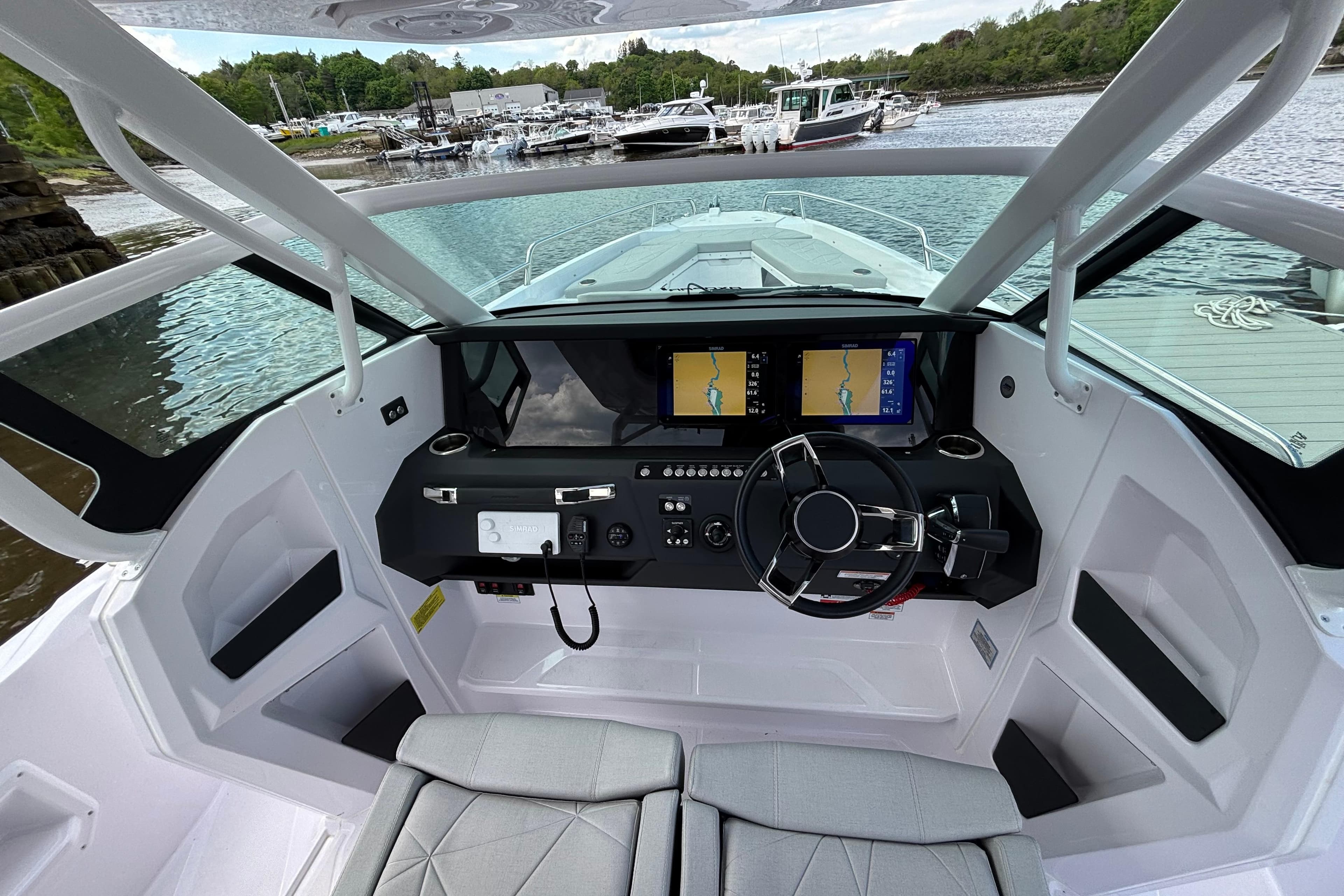 Interior view of 2025 Axopar 29 Sun-Top boat cockpit with modern navigation system.
