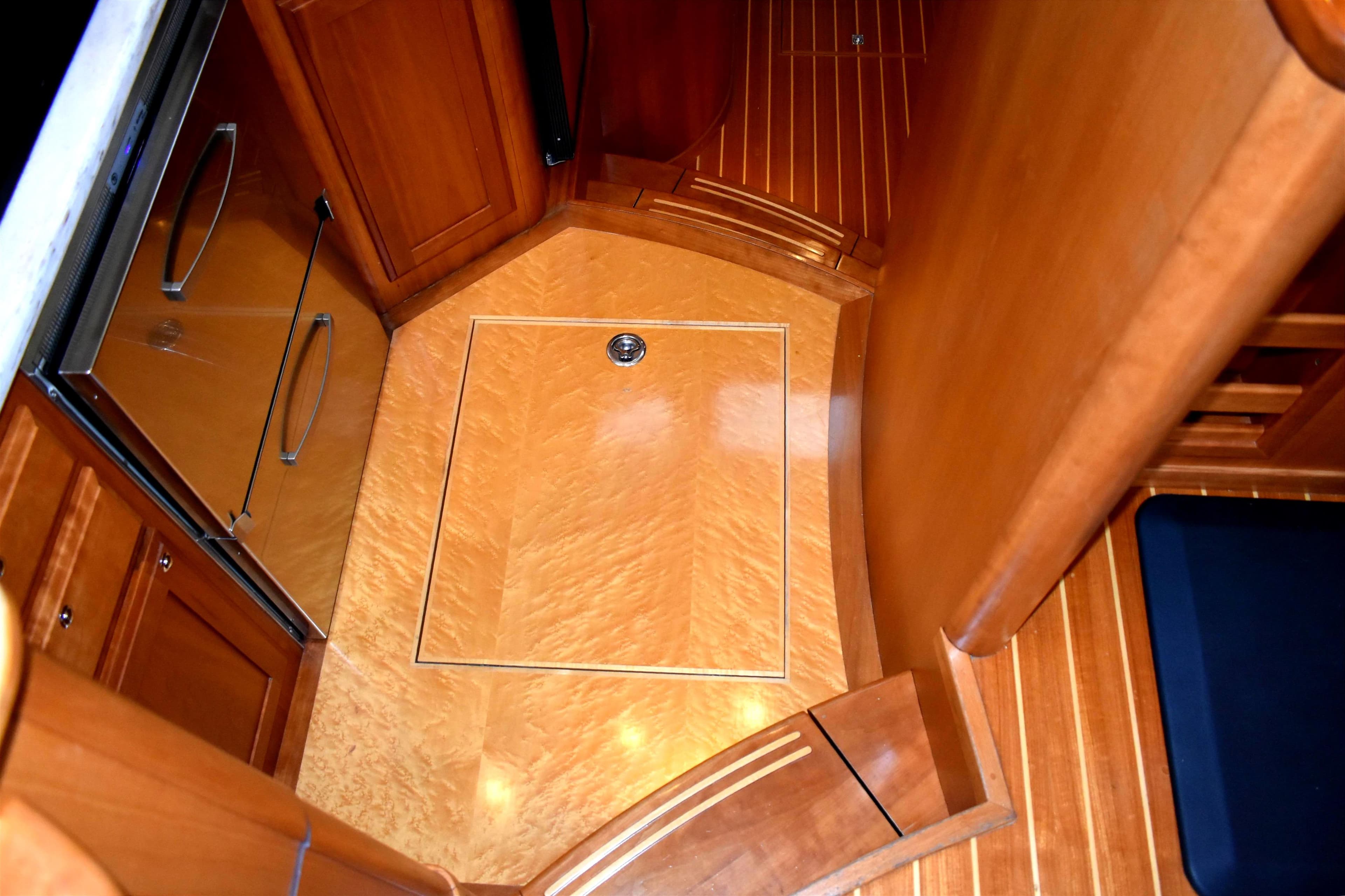 Birdseye Maple sole in galley, with storage below.