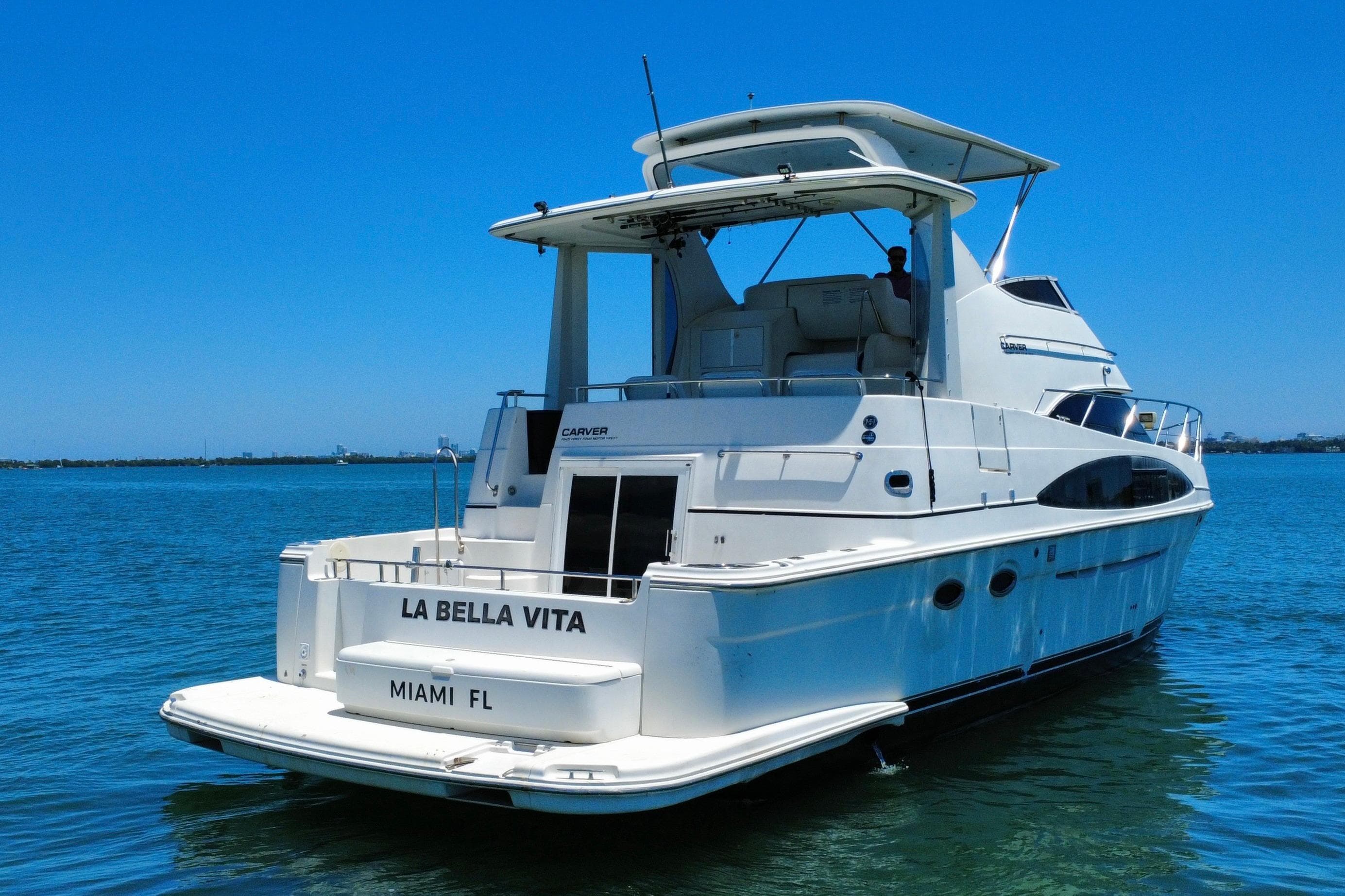 2004 Carver 444 Cockpit Motor Yacht on water, labeled "La Bella Vita," Miami, FL.