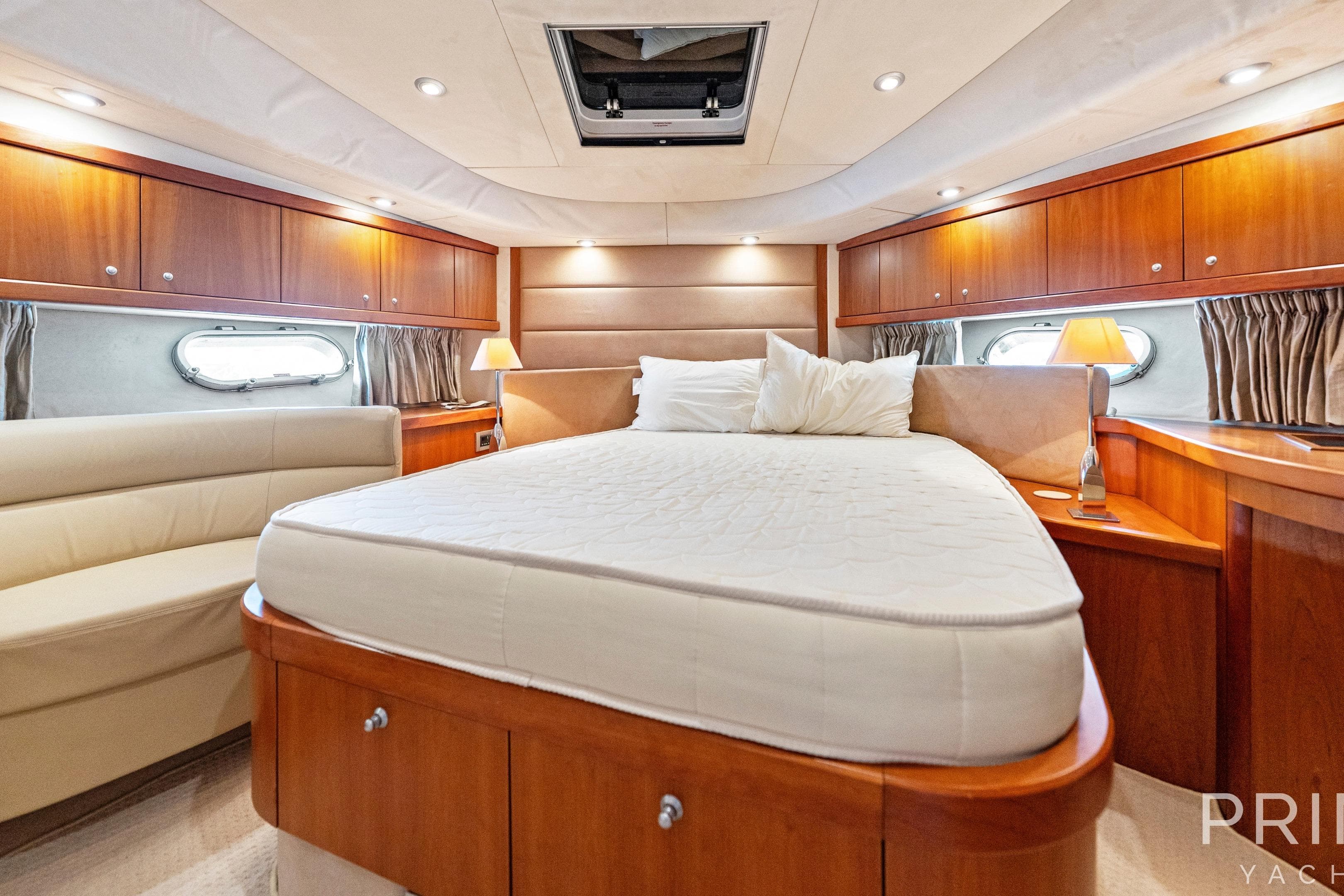 Luxurious bedroom interior of 2008 Sunseeker Manhattan 70 yacht with elegant wood finishes.
