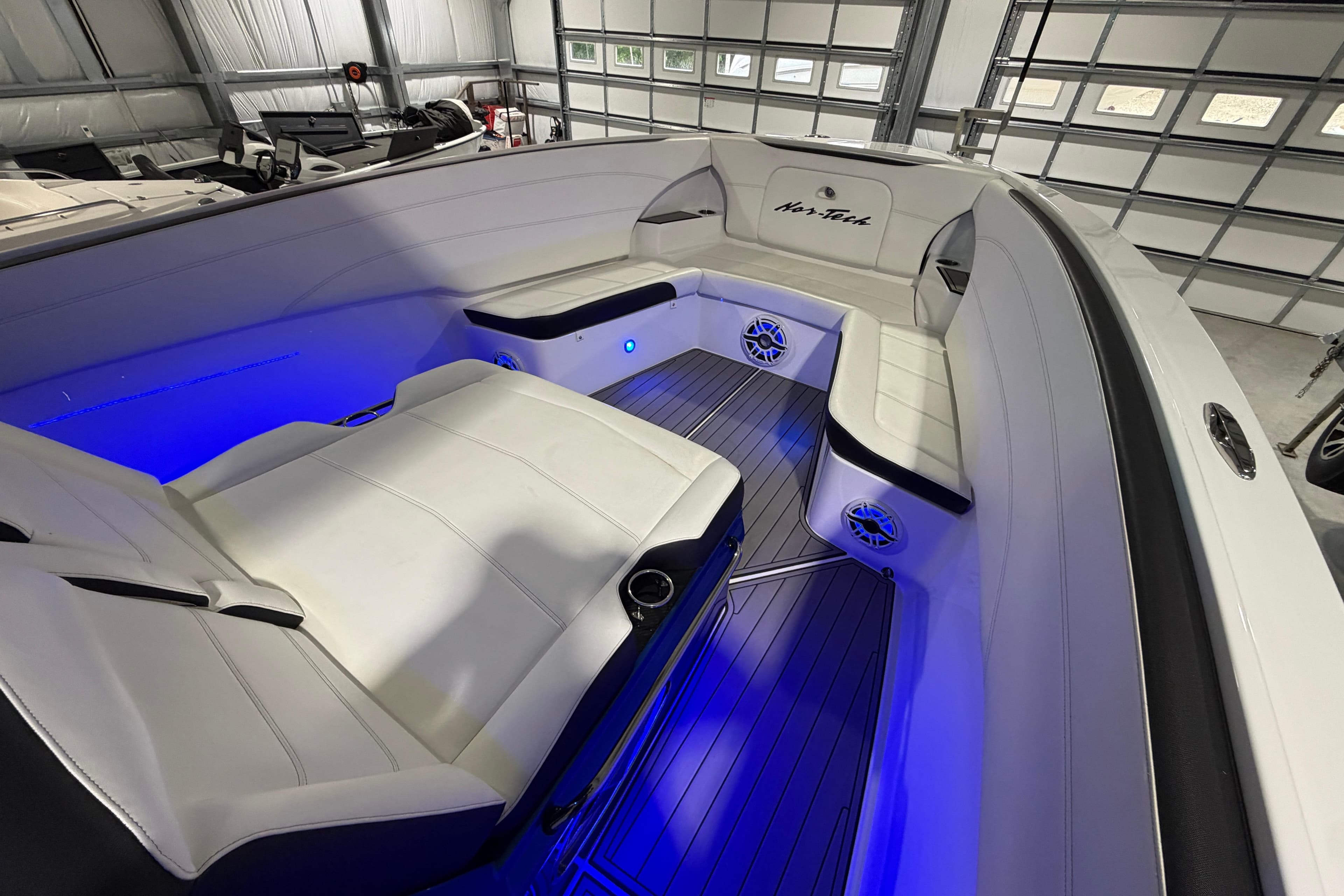 2020 Nor-Tech 340 Sport Center Console interior with blue LED lighting and white seating.