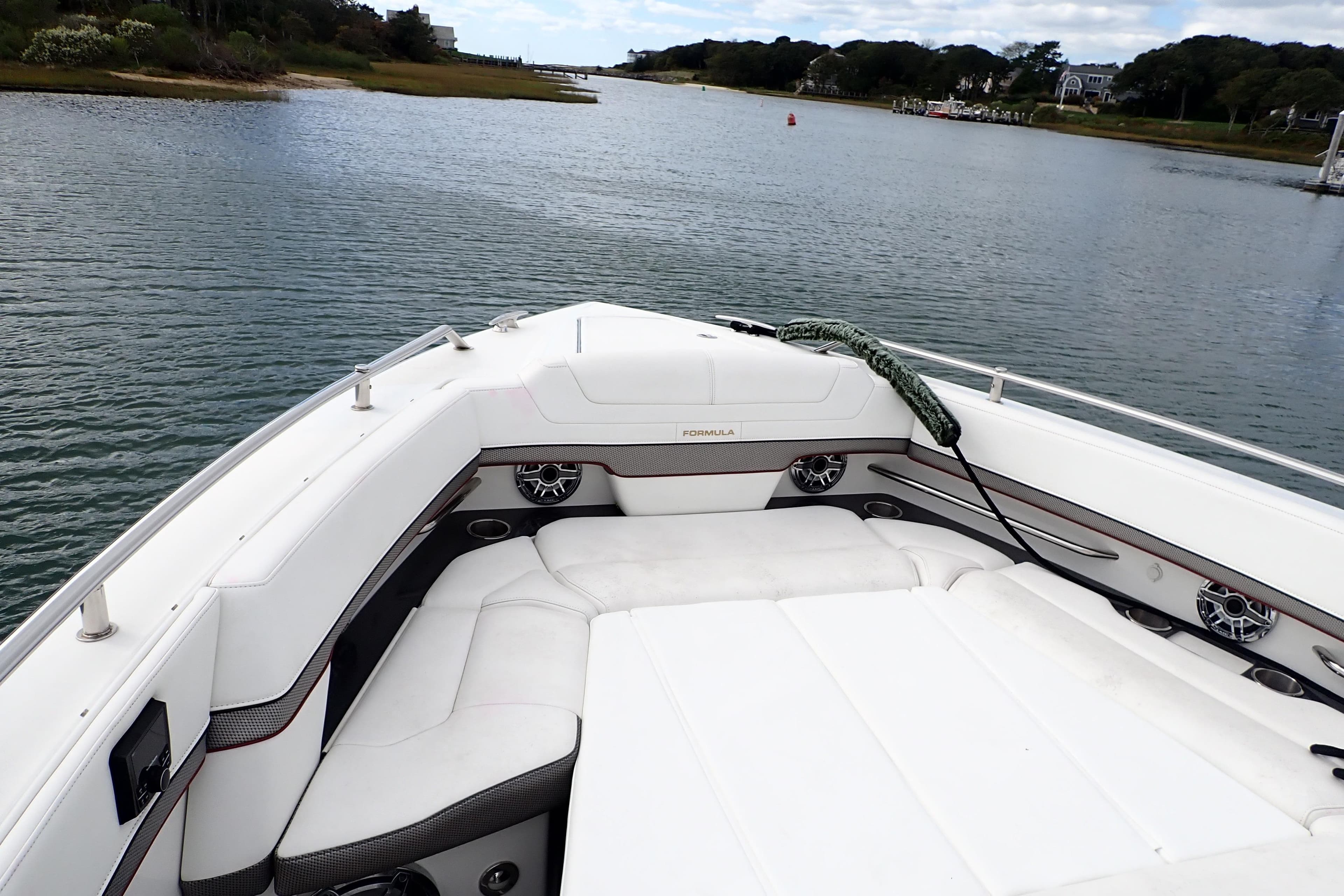 2022 Formula 380 Super Sport Crossover OB boat on calm water, featuring luxurious seating.