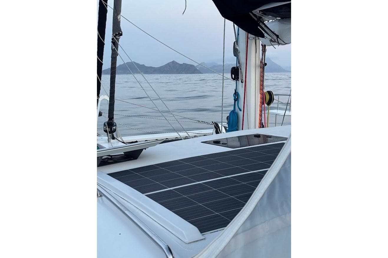 2023 Seawind 1600 Passagemaker with solar panels, sailing on calm waters.