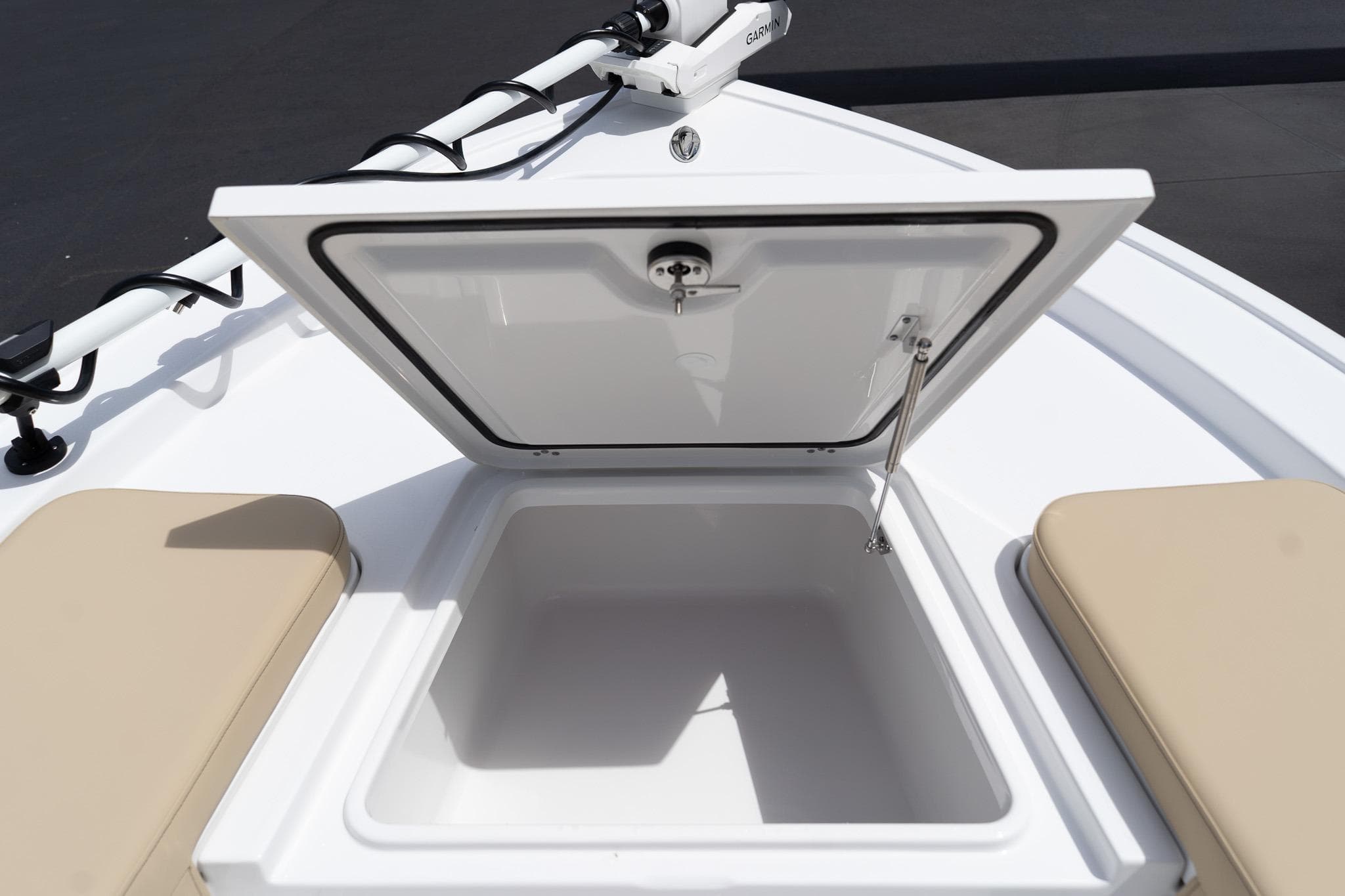 Open storage compartment on 2026 Sportsman Masters 247 Bay Boat, featuring beige seating.