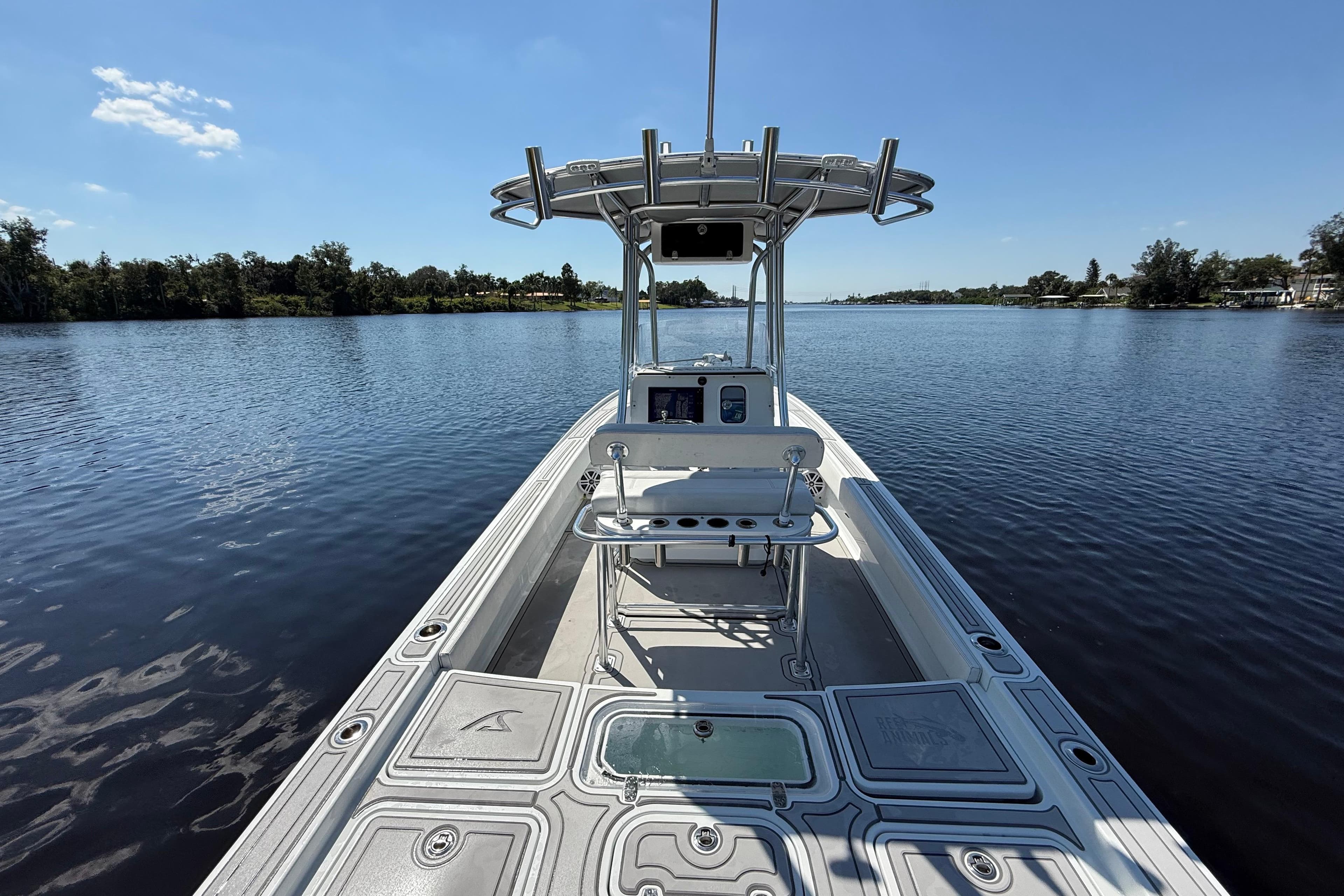 2024 Contender 26 Bay boat on calm water, showcasing sleek design and spacious deck.