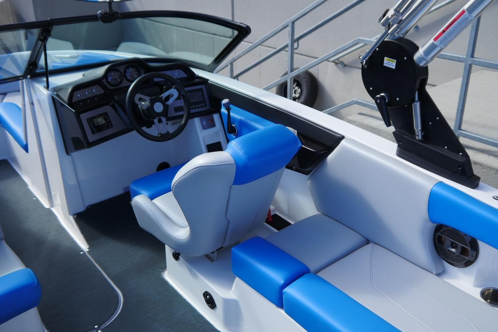 2020 MasterCraft NXT22 boat interior with blue and white seating and modern dashboard.
