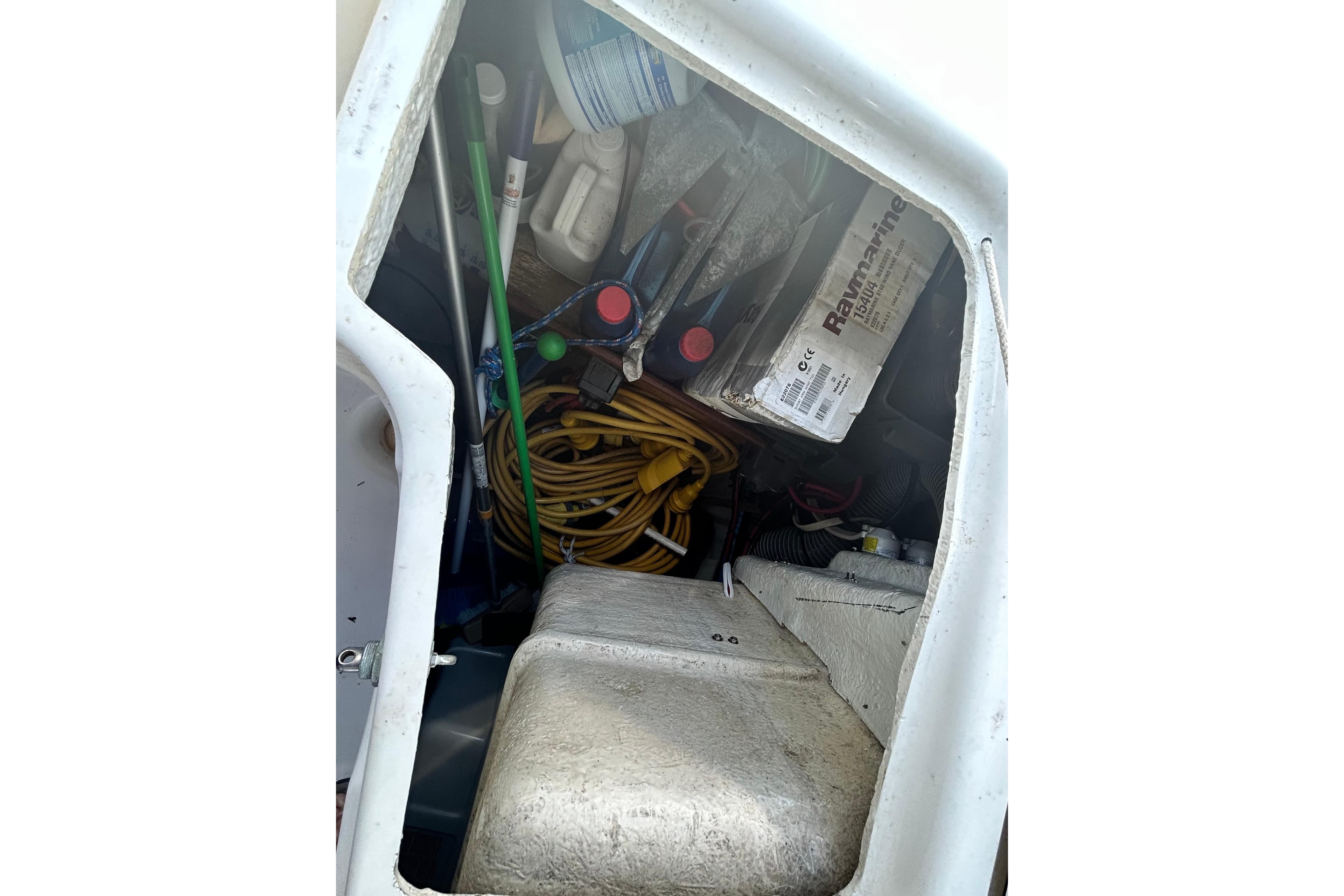 Storage compartment of a 2008 Beneteau Oceanis 46 sailboat with various equipment and supplies.