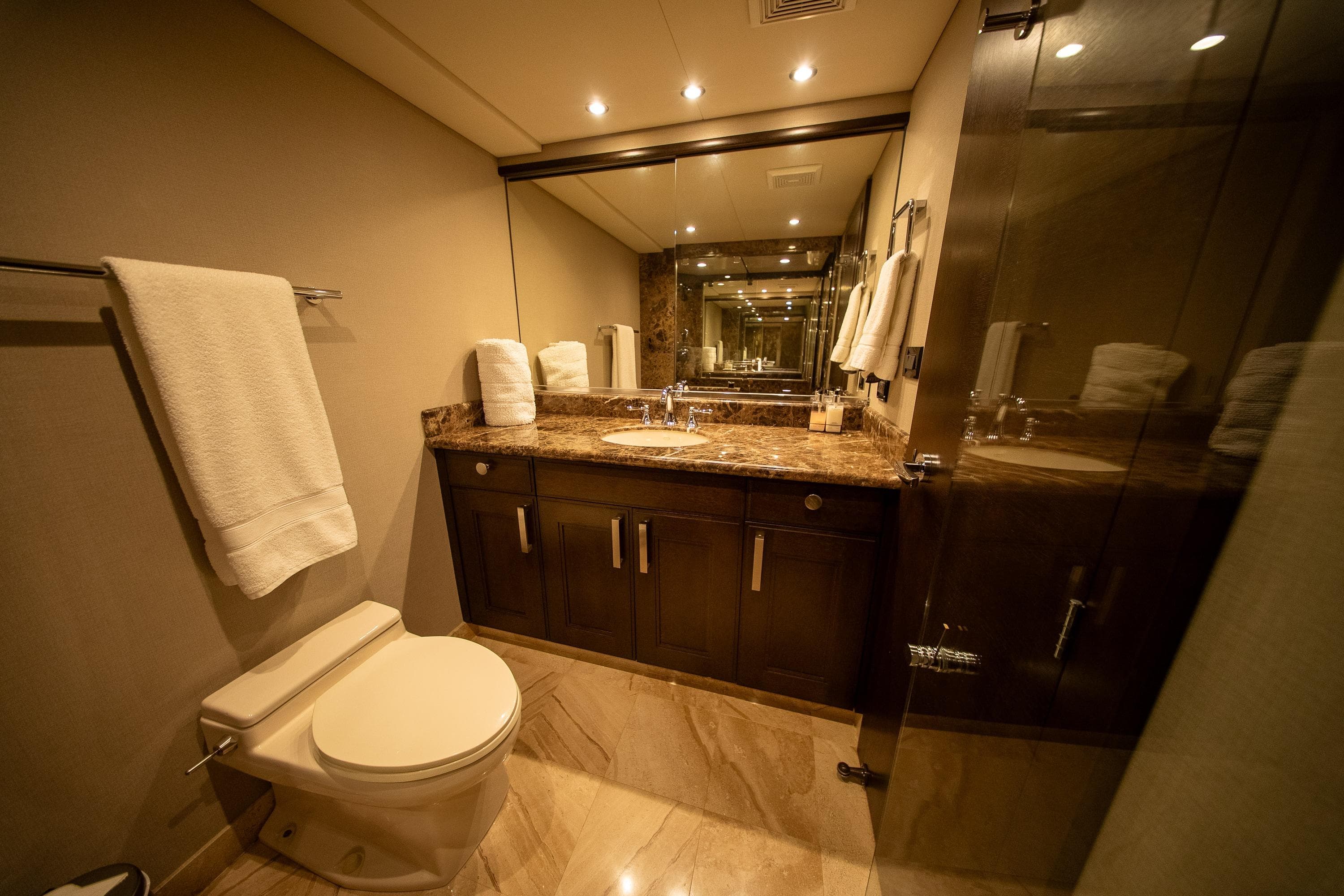 Luxurious bathroom with marble countertop, elegant lighting, and modern fixtures in a 1992 Crescent Custom.