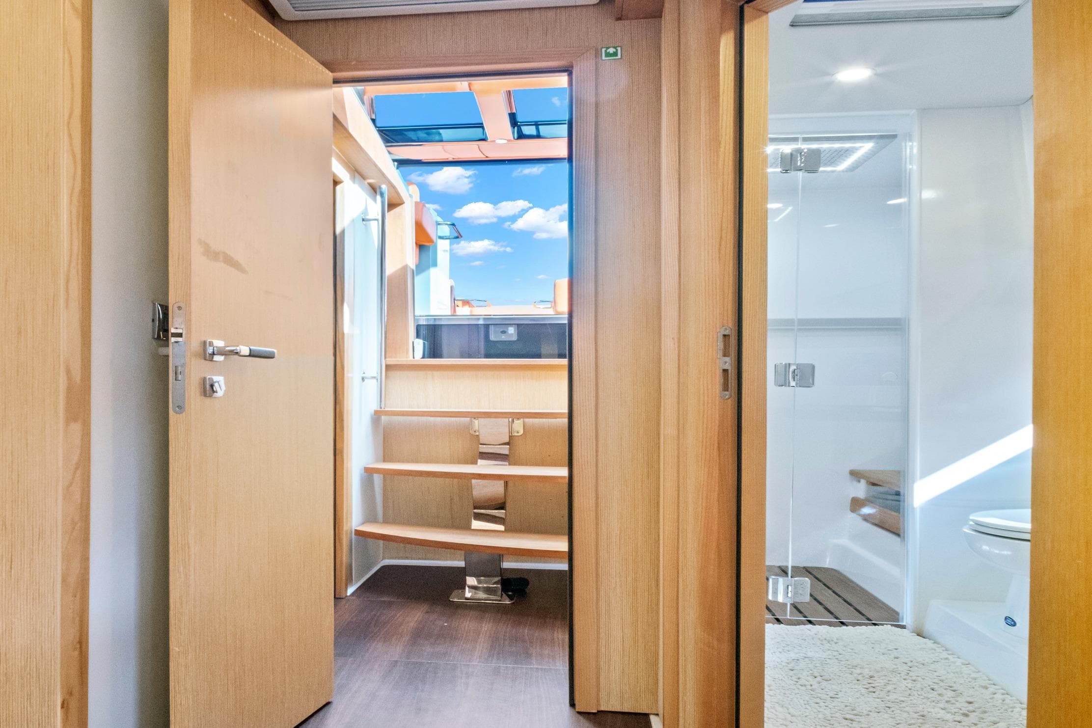 Interior view of 2019 Fjord 52 Open yacht, featuring wooden doors and modern design.