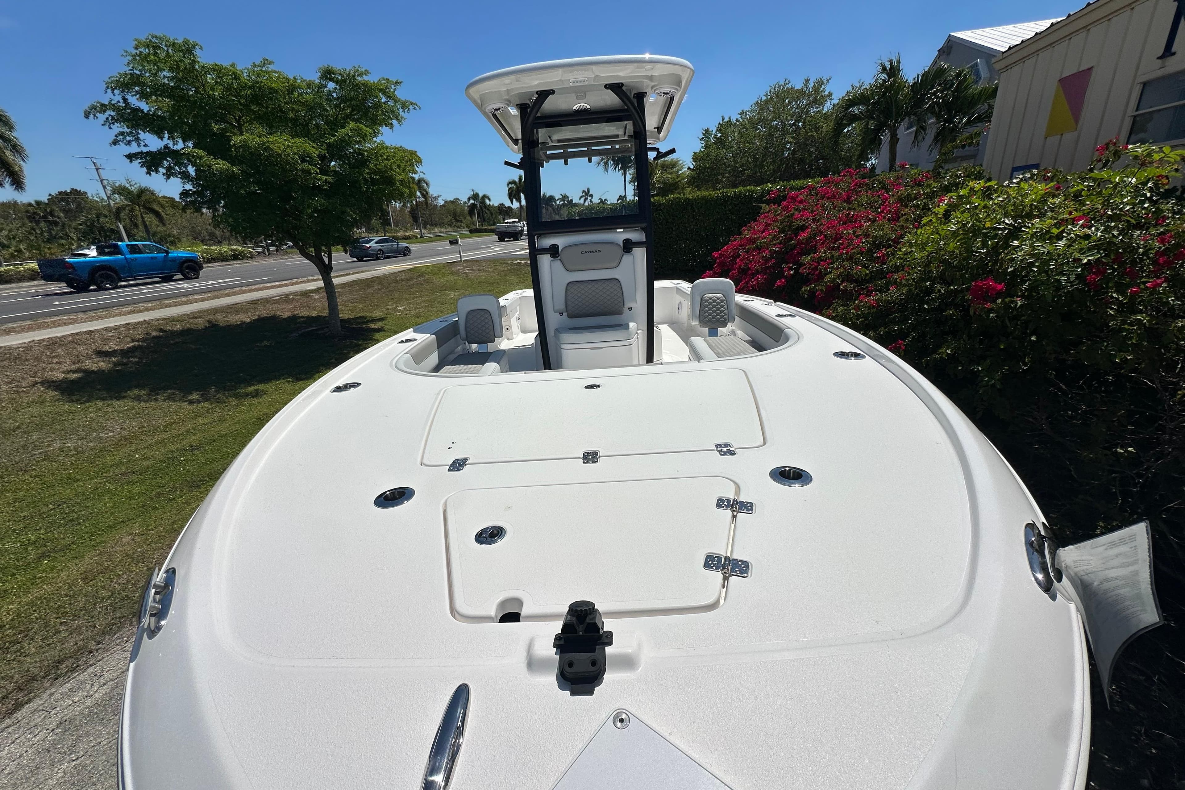2026 Caymas 26 HB boat with sleek white deck, parked outdoors.