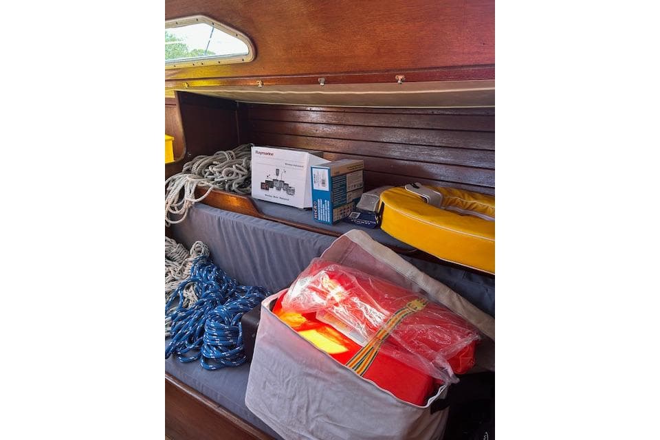 Interior of 1982 Ericson 33 sailboat with ropes, life jackets, and equipment.