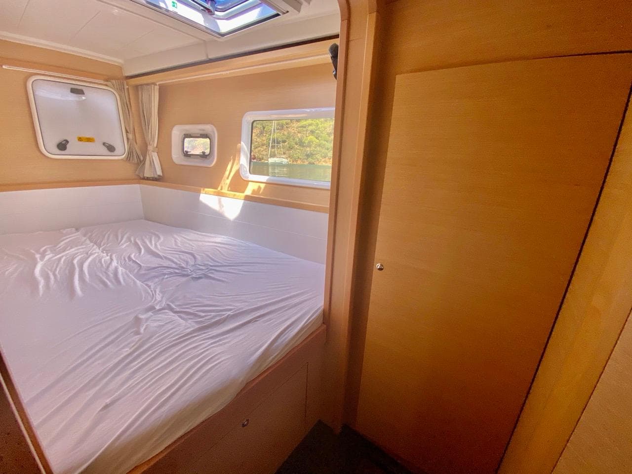 Interior cabin of 2016 Lagoon 39 catamaran with bed and window.