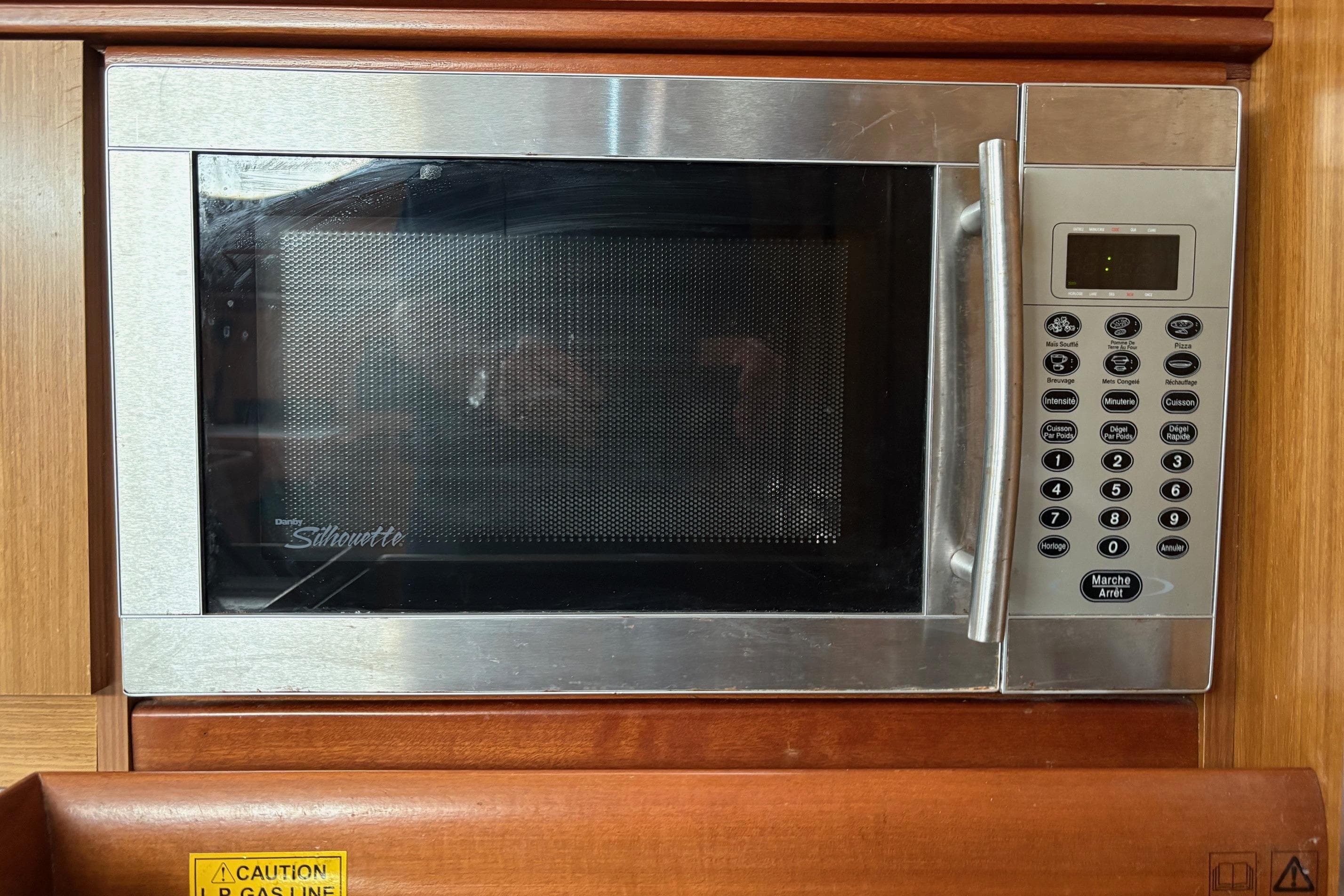 Microwave oven in Jeanneau Sun Odyssey 42 DS yacht, 2007 model, with control panel.
