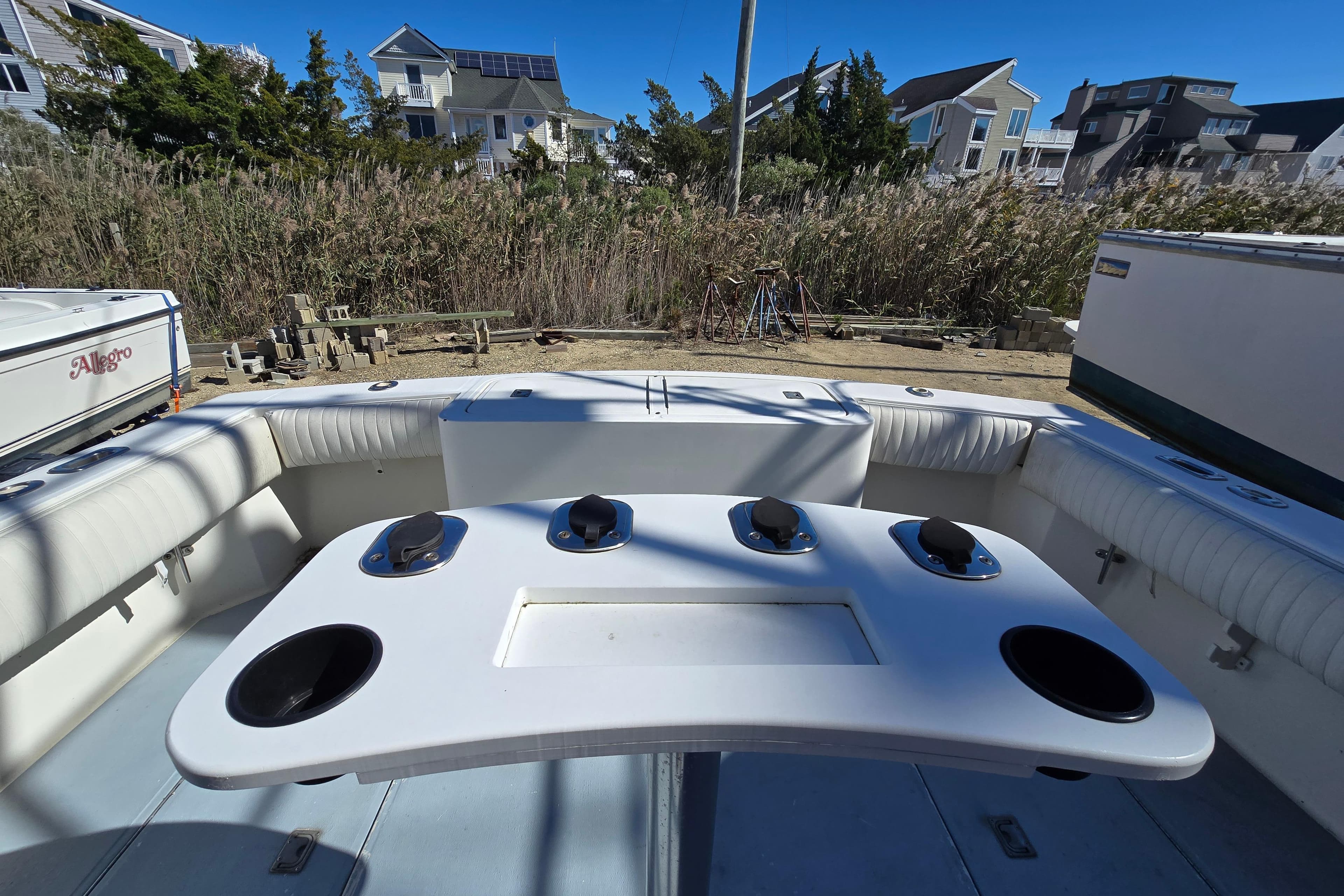2002 Carolina Classic 28 Express boat interior with fishing rod holders and seating.