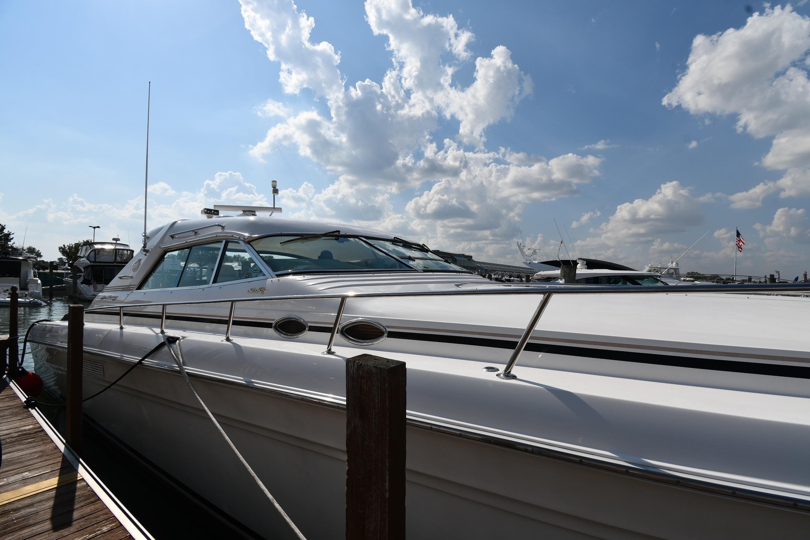 1995 Sea Ray 630 Sundancer yacht docked under a partly cloudy sky.
