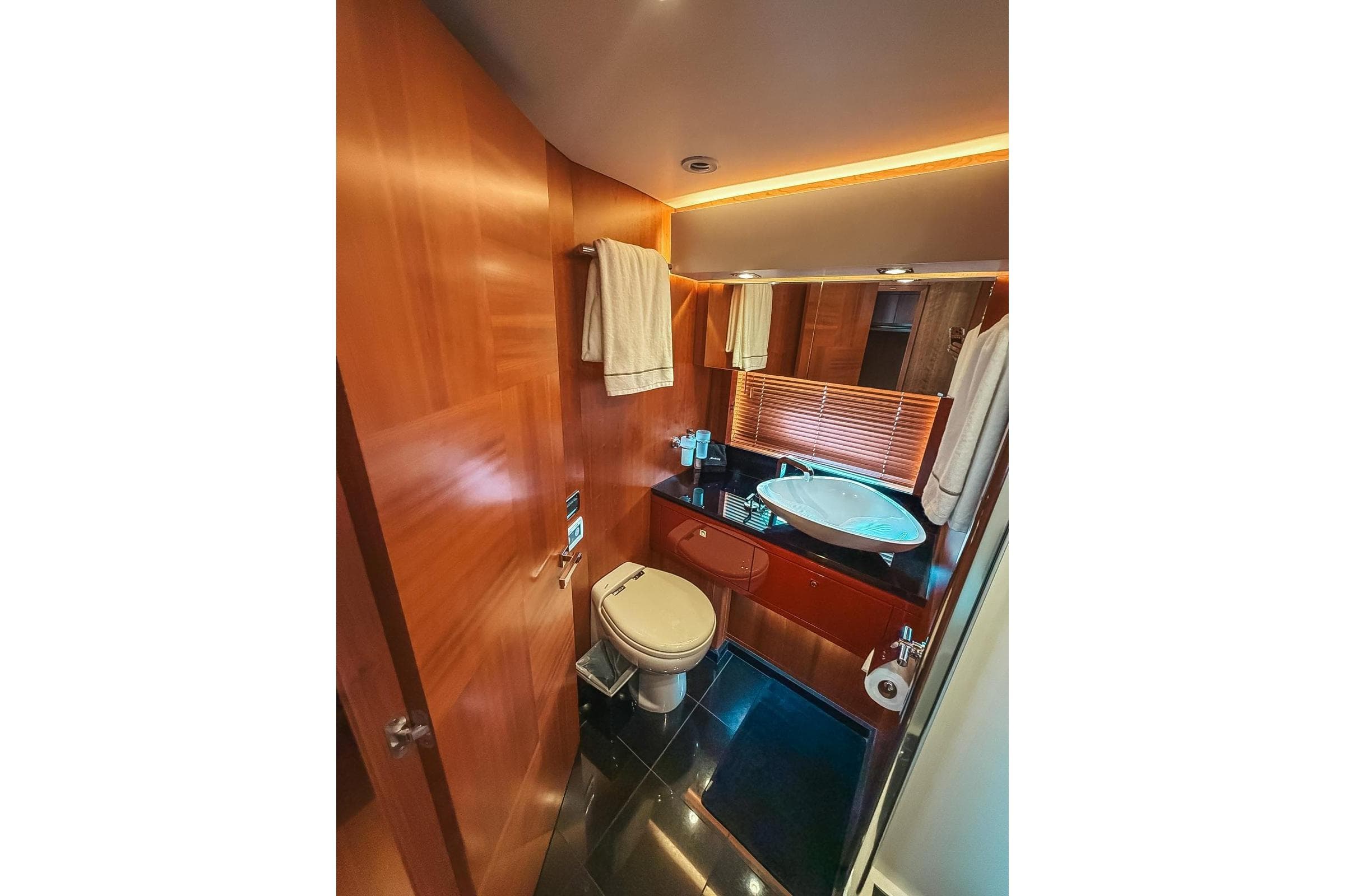 Luxurious bathroom in 2010 Sunseeker Predator 84 yacht with modern fixtures and wood accents.