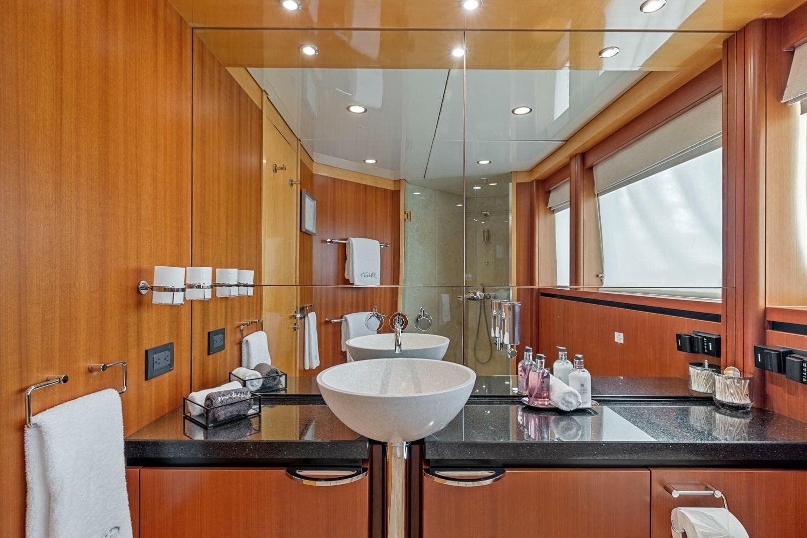 Luxurious bathroom on 2005 New Zealand Yachts 115 Wave Piercer, featuring modern fixtures and elegant wood paneling.