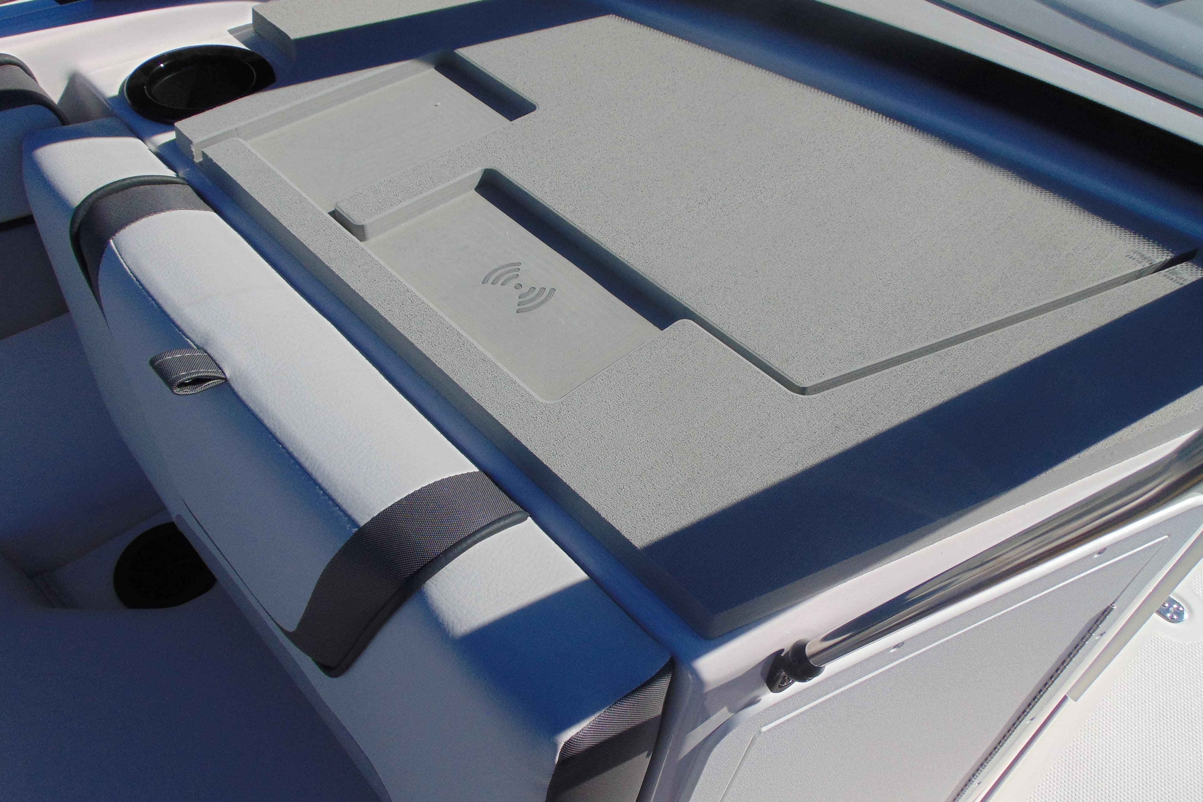 2026 Yamaha Boats AR220 interior with wireless charging pad and cup holders.