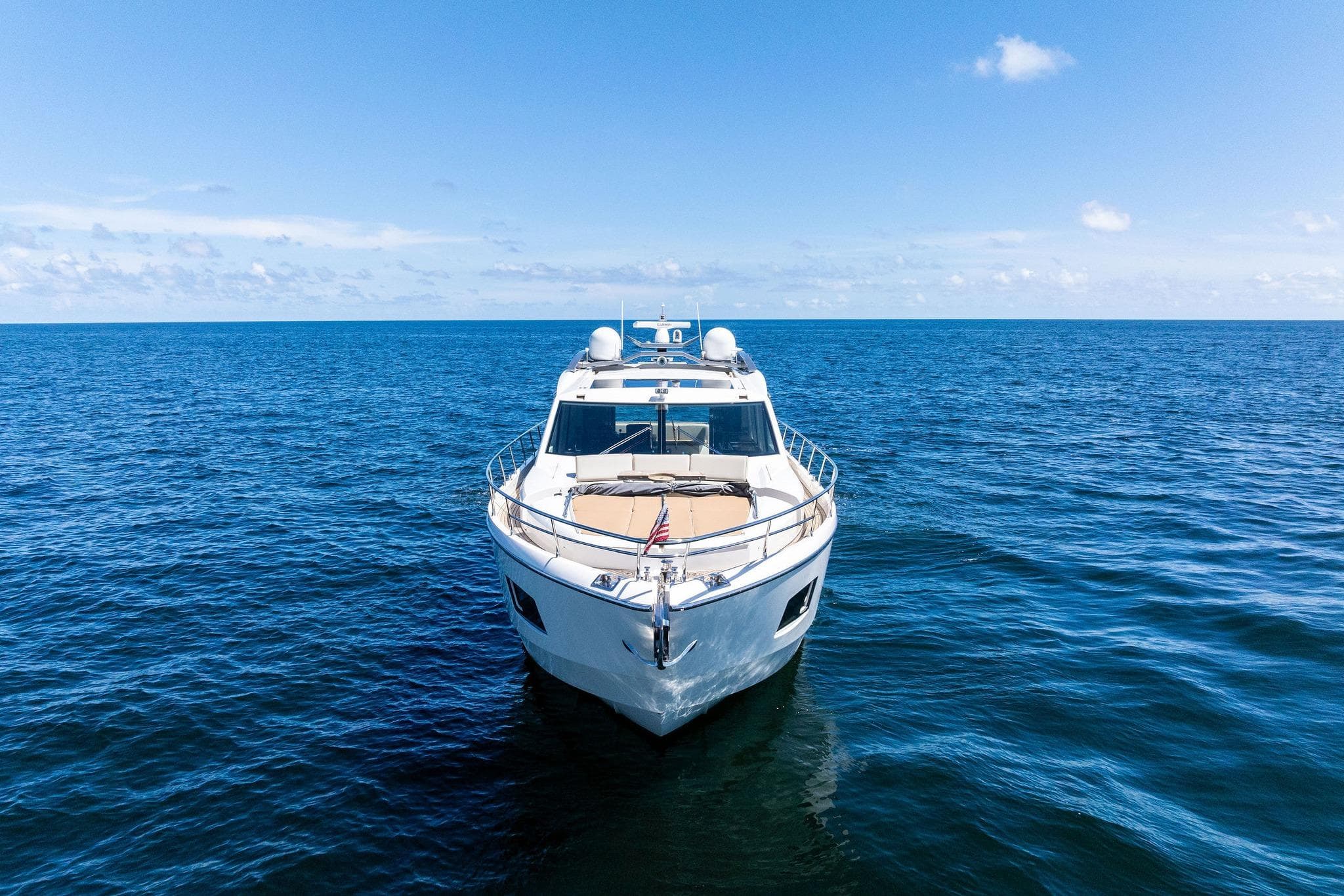 Luxury Absolute 64 yacht cruising on open sea under clear blue sky, 2013 model.