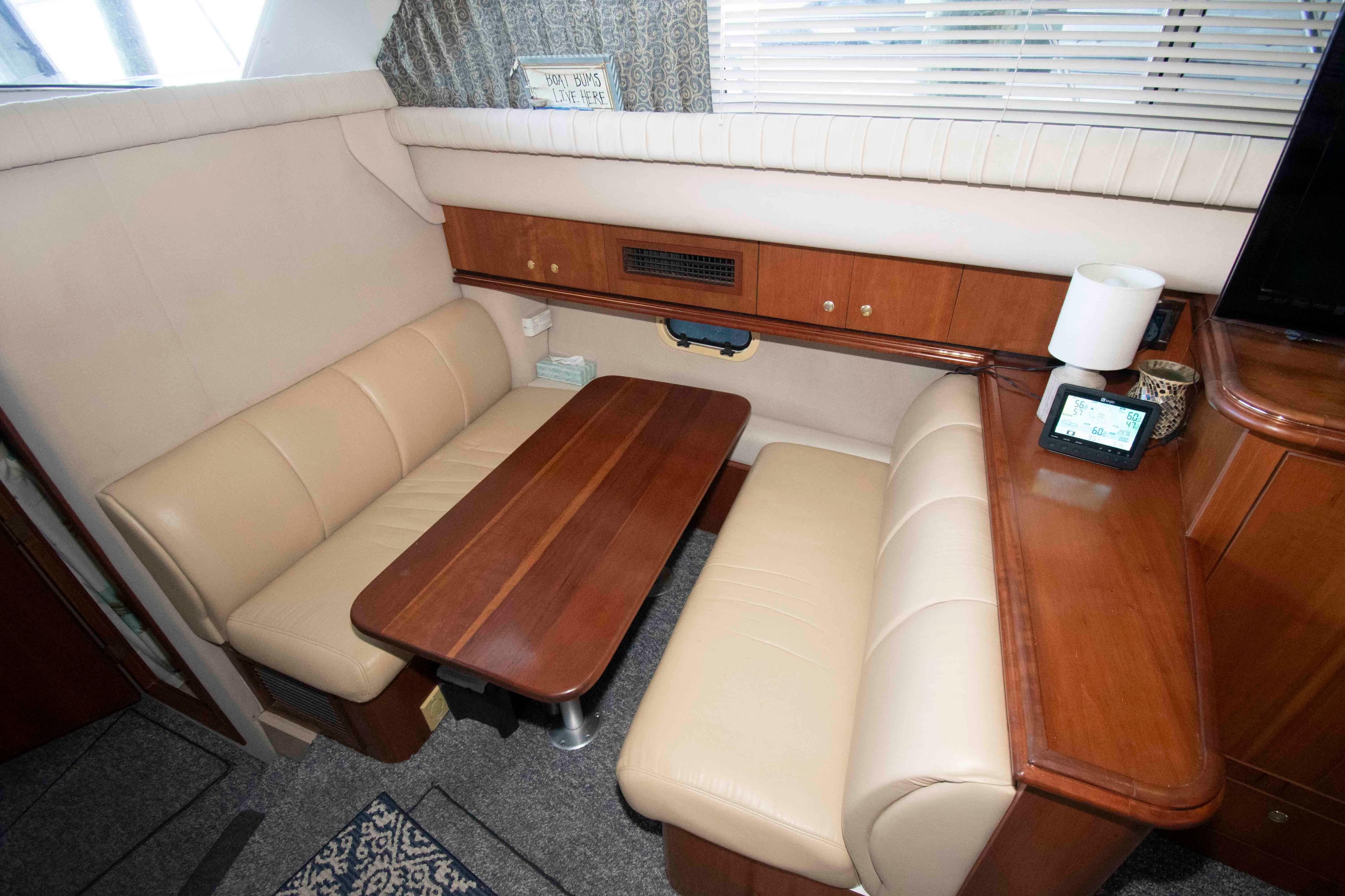 Interior of 2001 Cruisers Yachts 3750 Motoryacht with beige seating and wooden table.
