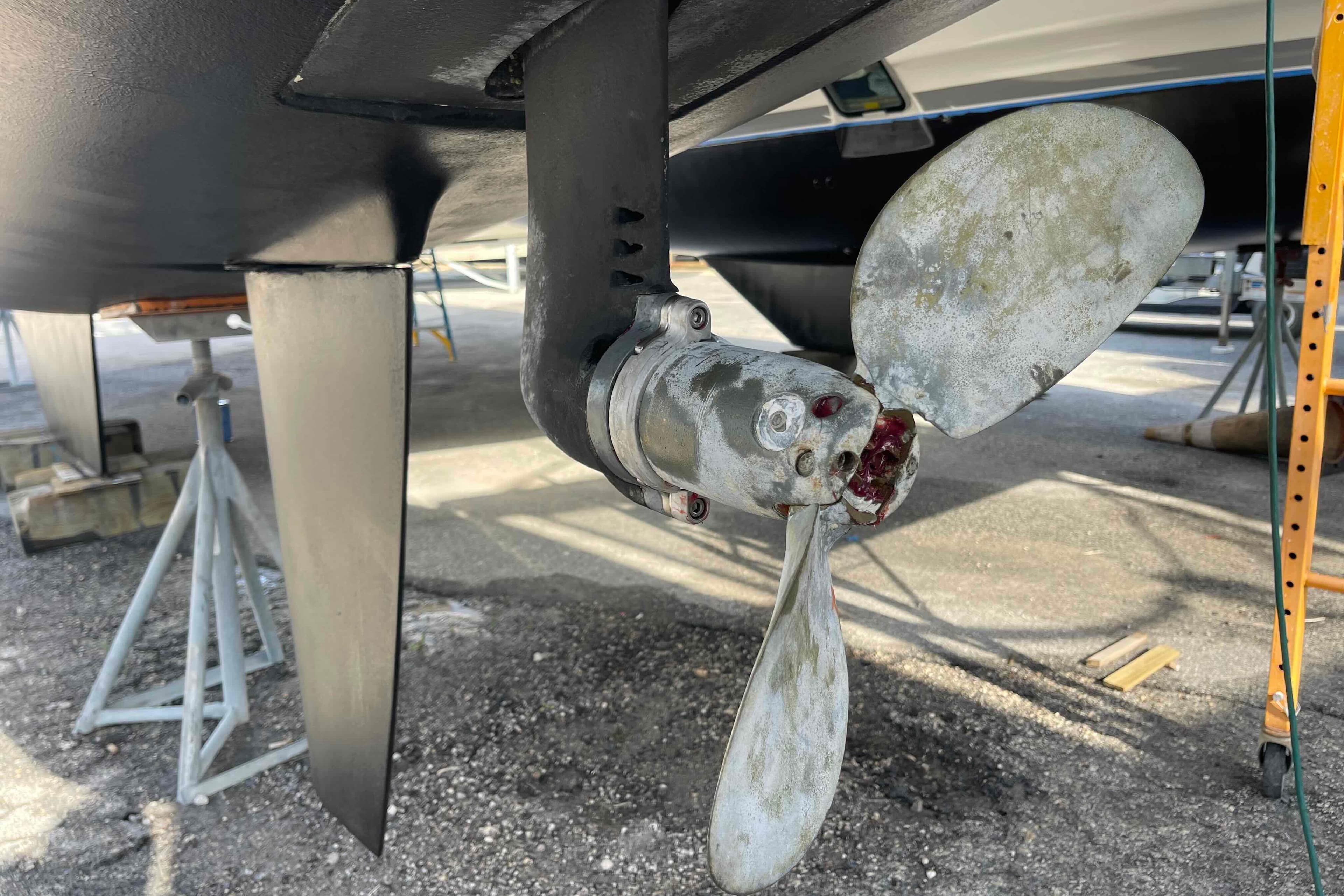 Propeller of 2012 Lagoon 380 S2 catamaran on dry dock, showing wear and maintenance needs.