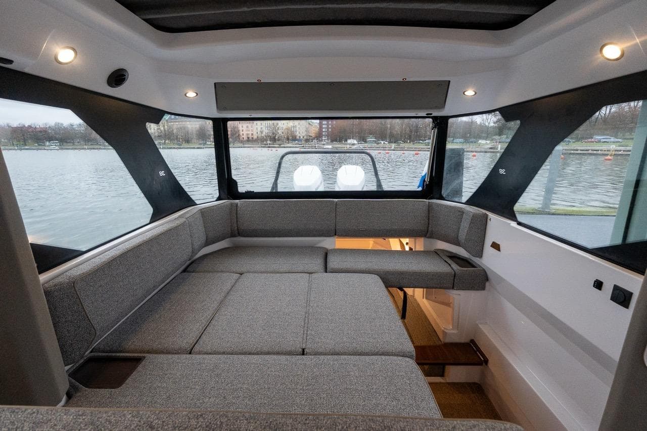 2027 Axopar 38 Cross Cabin interior with panoramic windows and comfortable seating.