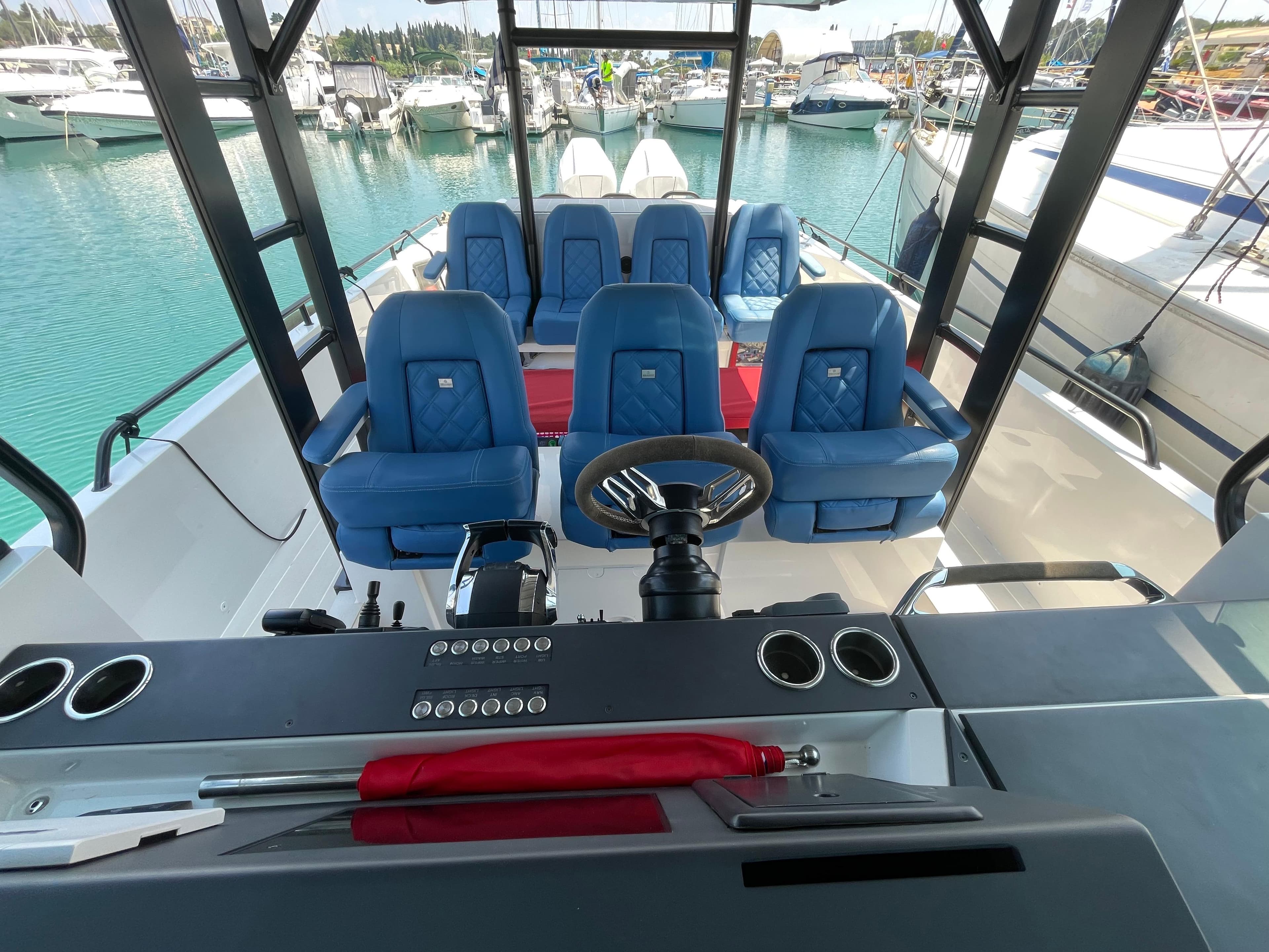 2019 Axopar 37 ST Brabus Line boat interior with blue seating and steering wheel.