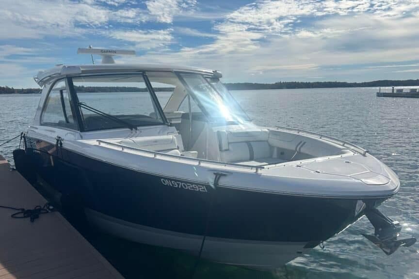 2025 Regal LS36 boat docked on a sunny day with calm waters.