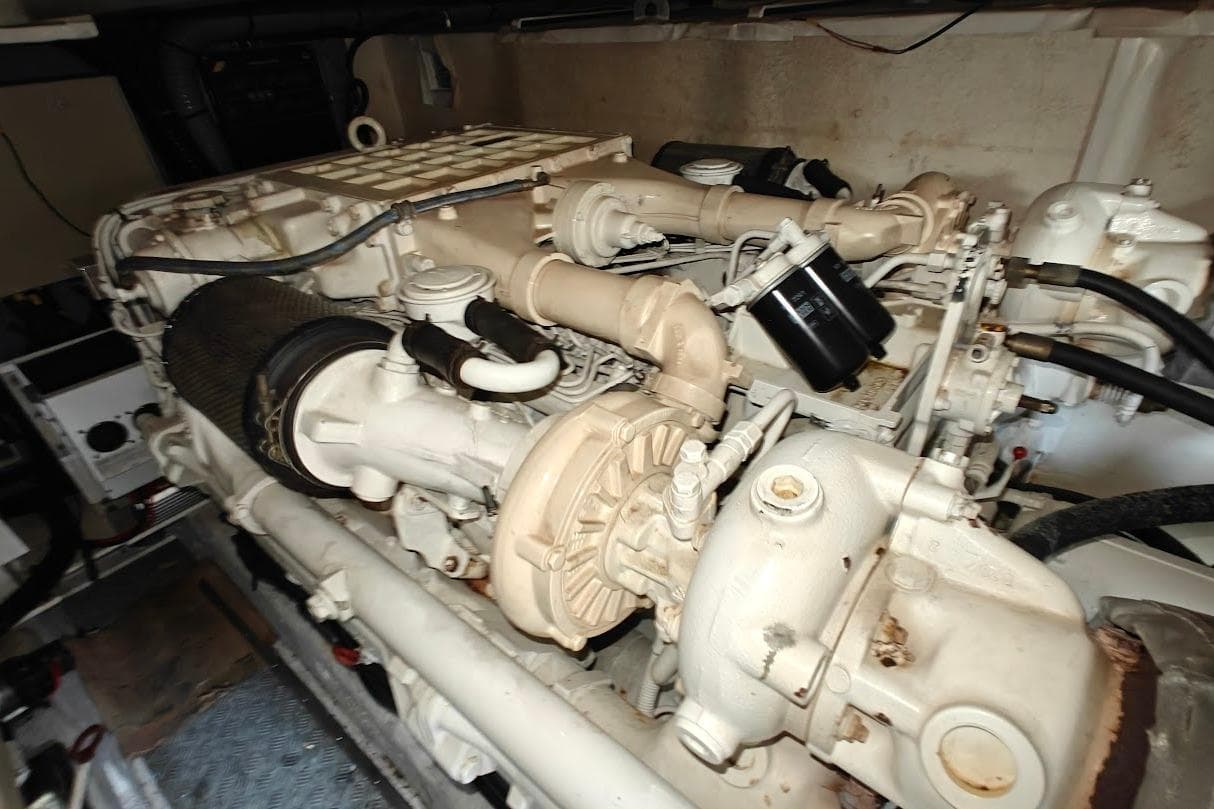 Engine room of a 2003 Princess 65 yacht, showcasing detailed mechanical components.
