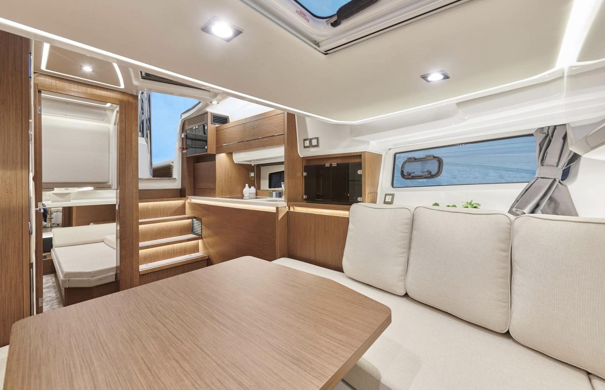 Interior of 2021 Jeanneau Leader 12.5 yacht with modern design and comfortable seating.