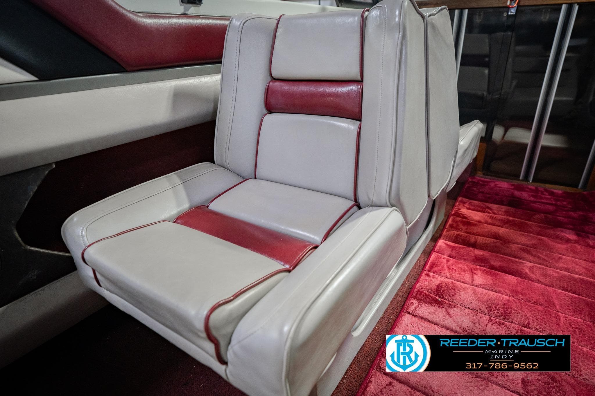 Red and white leather seat in 1986 Regal Sebring 195 boat interior.
