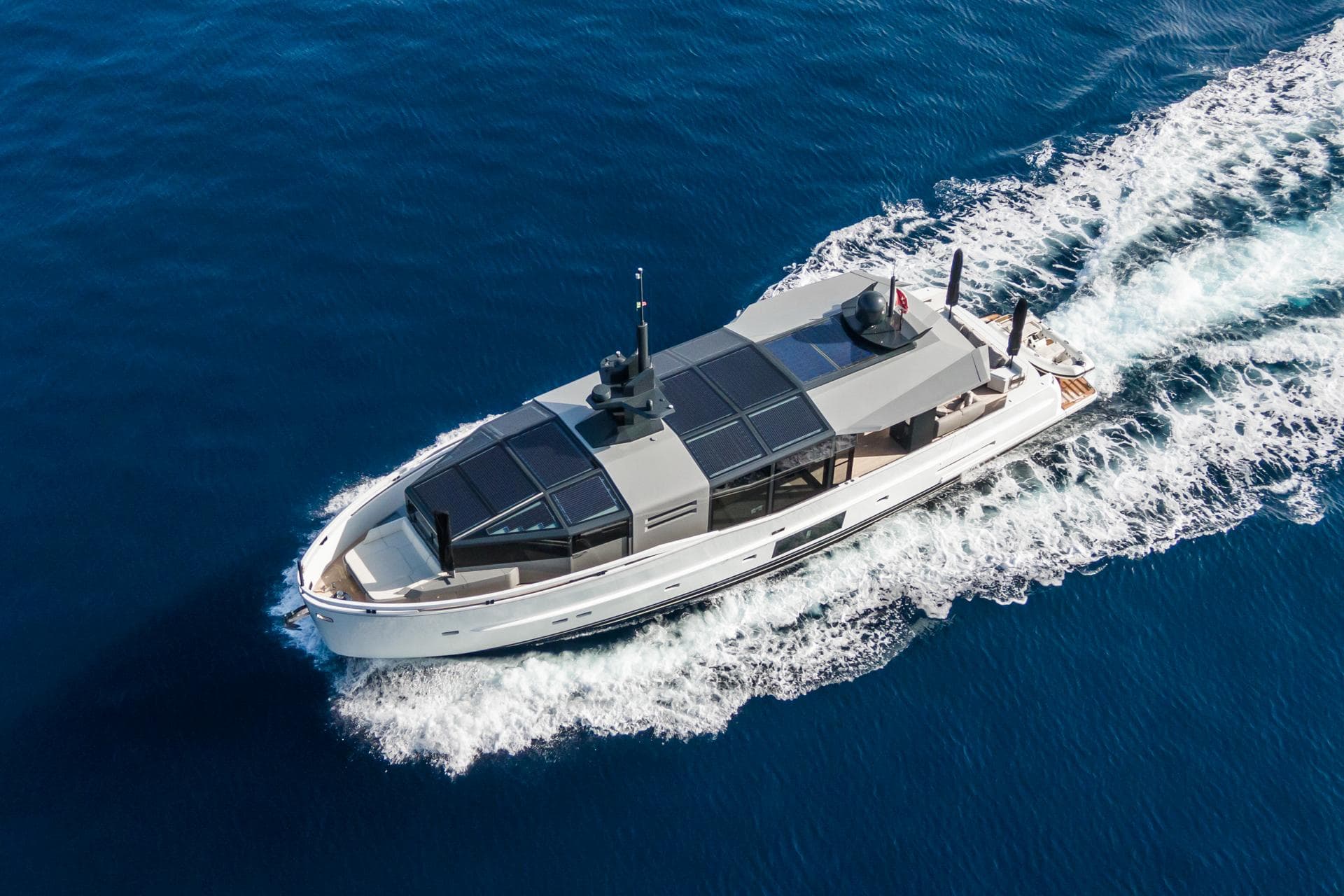 2019 Arcadia Yachts A85 cruising on open blue sea, aerial view.