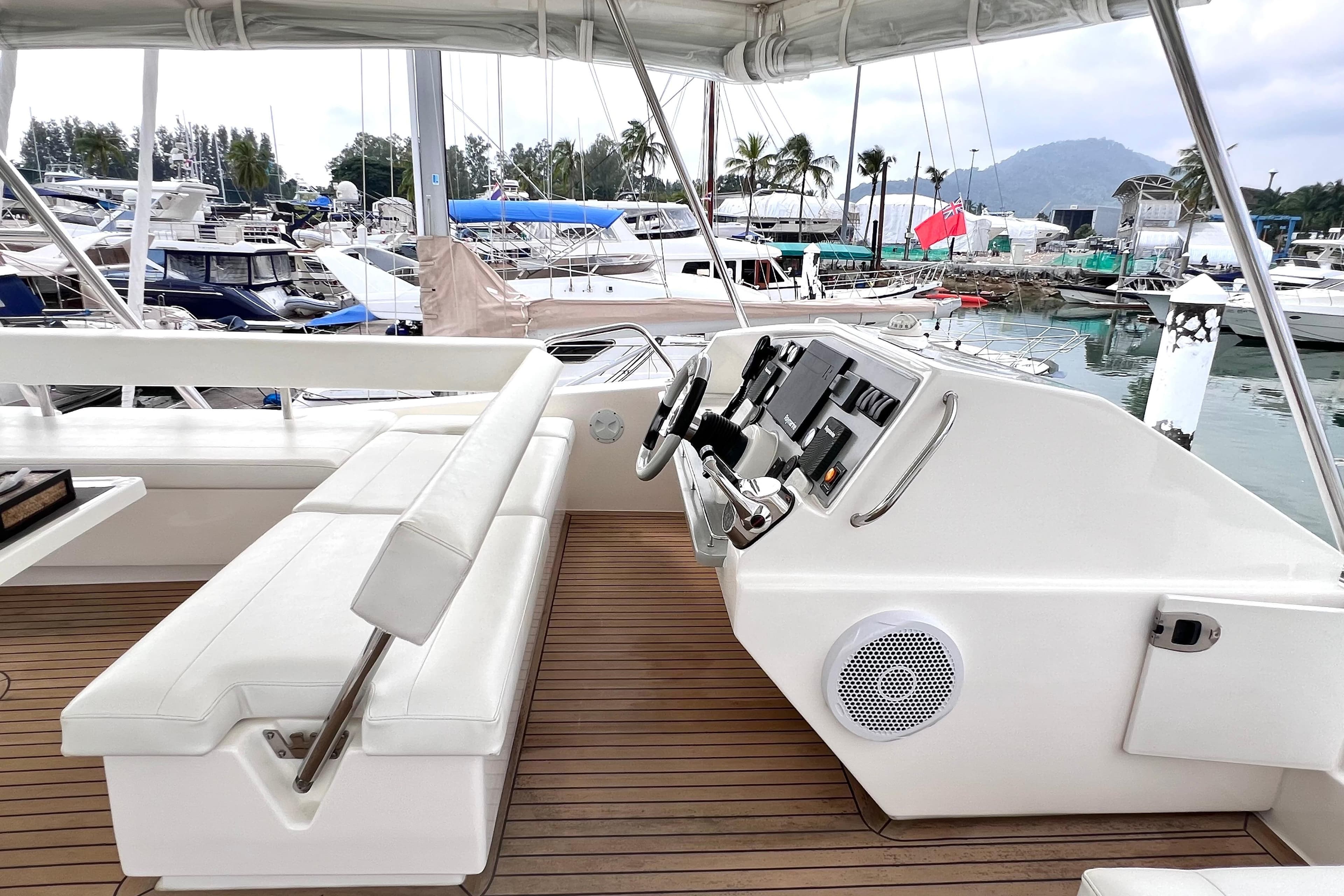 Helm of 2019 Leopard 51 Powercat with white seating, docked in marina.