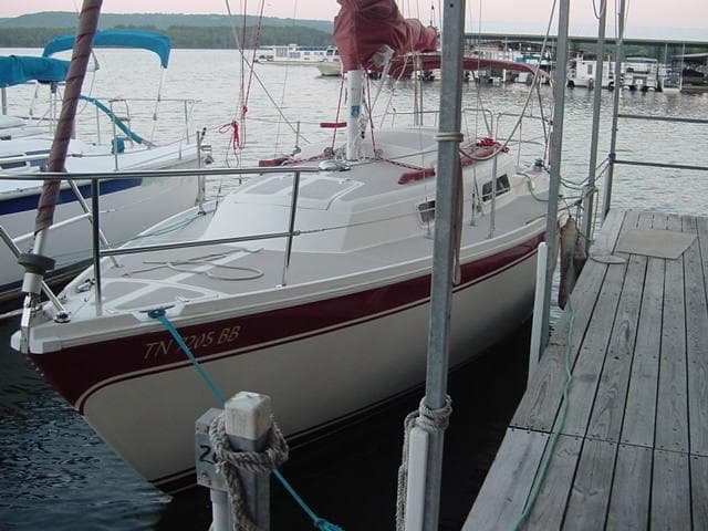 1981 CAL 25II Mk II sailboat docked at a marina with scenic background.