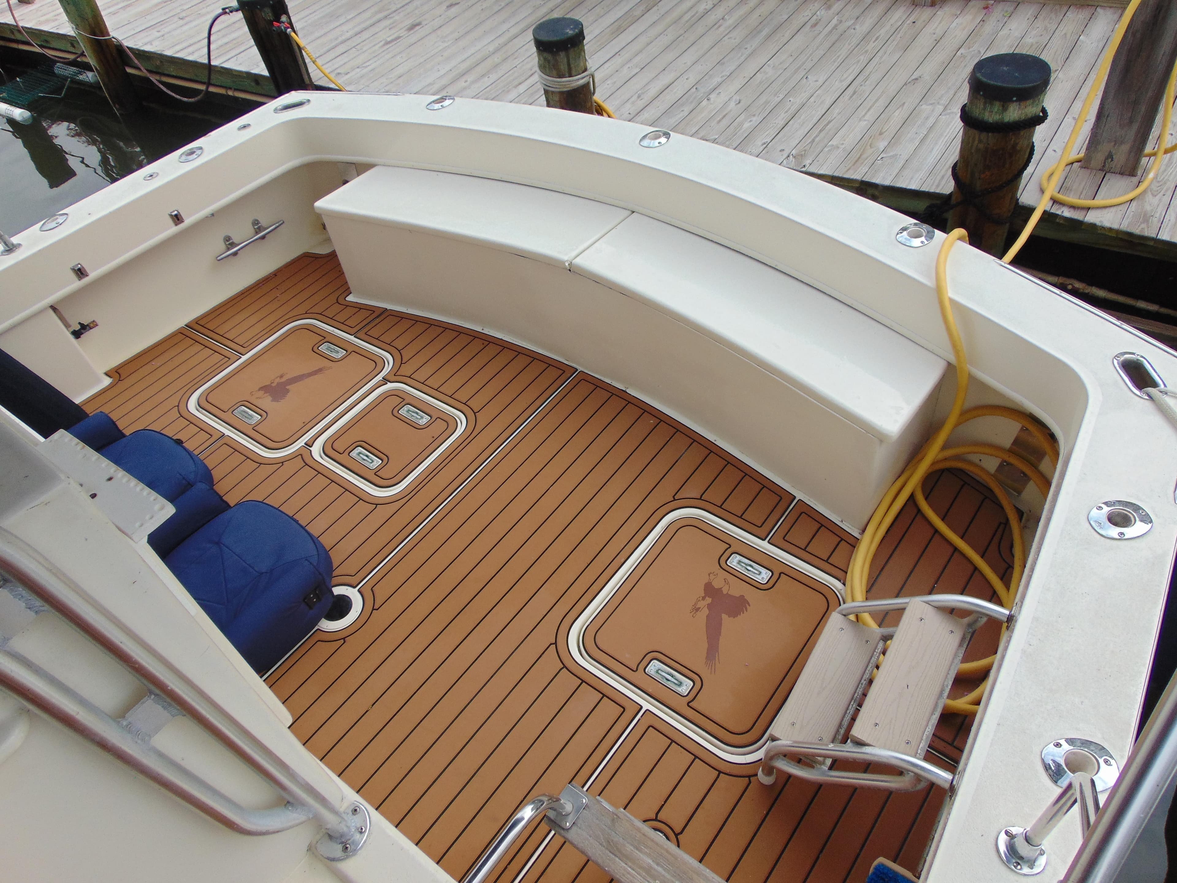 1972 Hatteras Yachtfish deck with teak flooring and seating area.