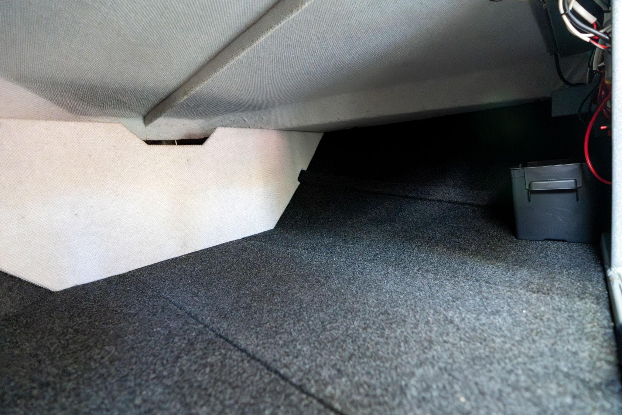 Interior storage space of 2021 KingFisher 2825 Coastal Express boat, featuring carpeted flooring.