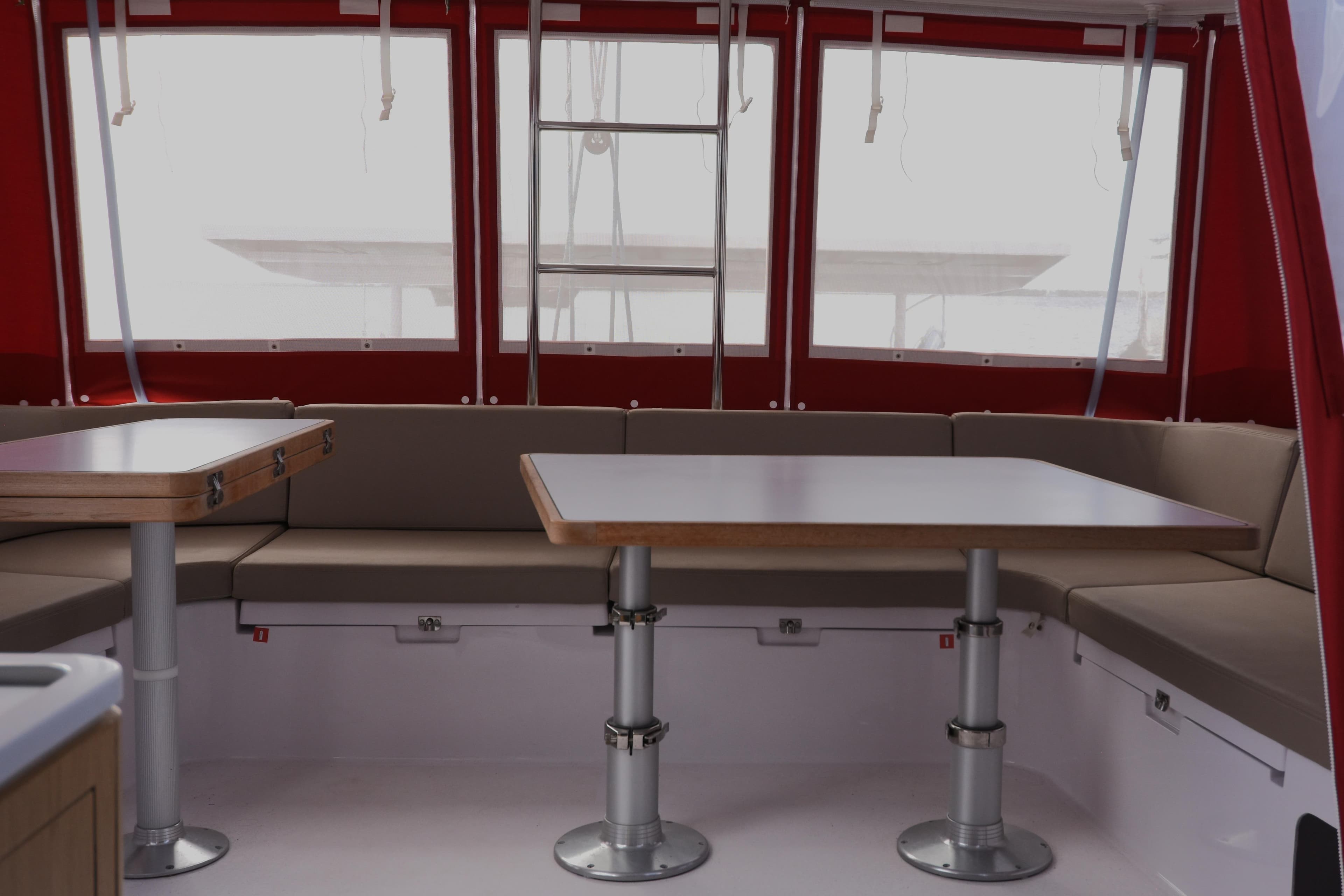 Interior of 2021 Outremer 51 catamaran with red accents and modern seating area.