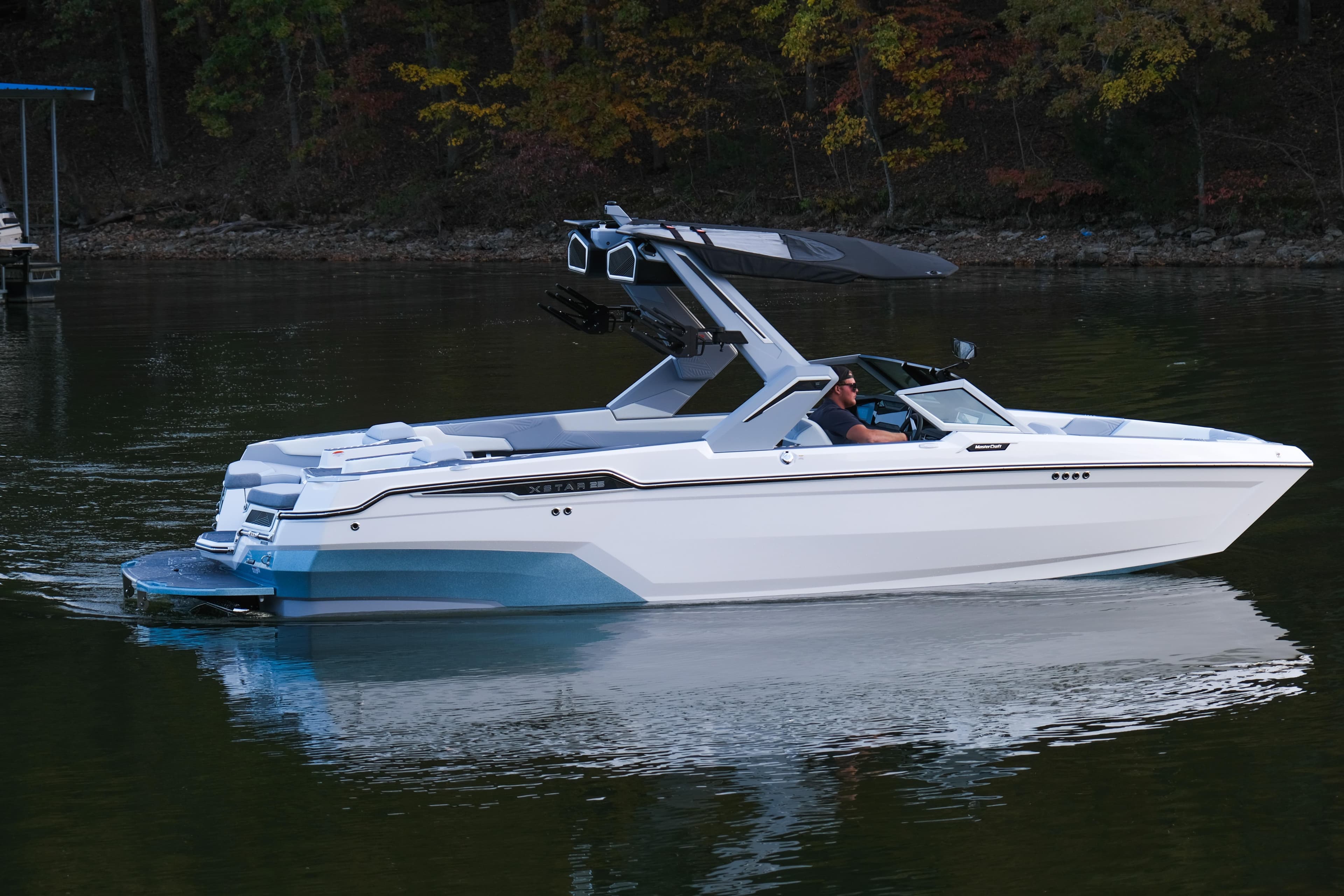 2026 MasterCraft XStar 25 boat cruising on a calm lake.