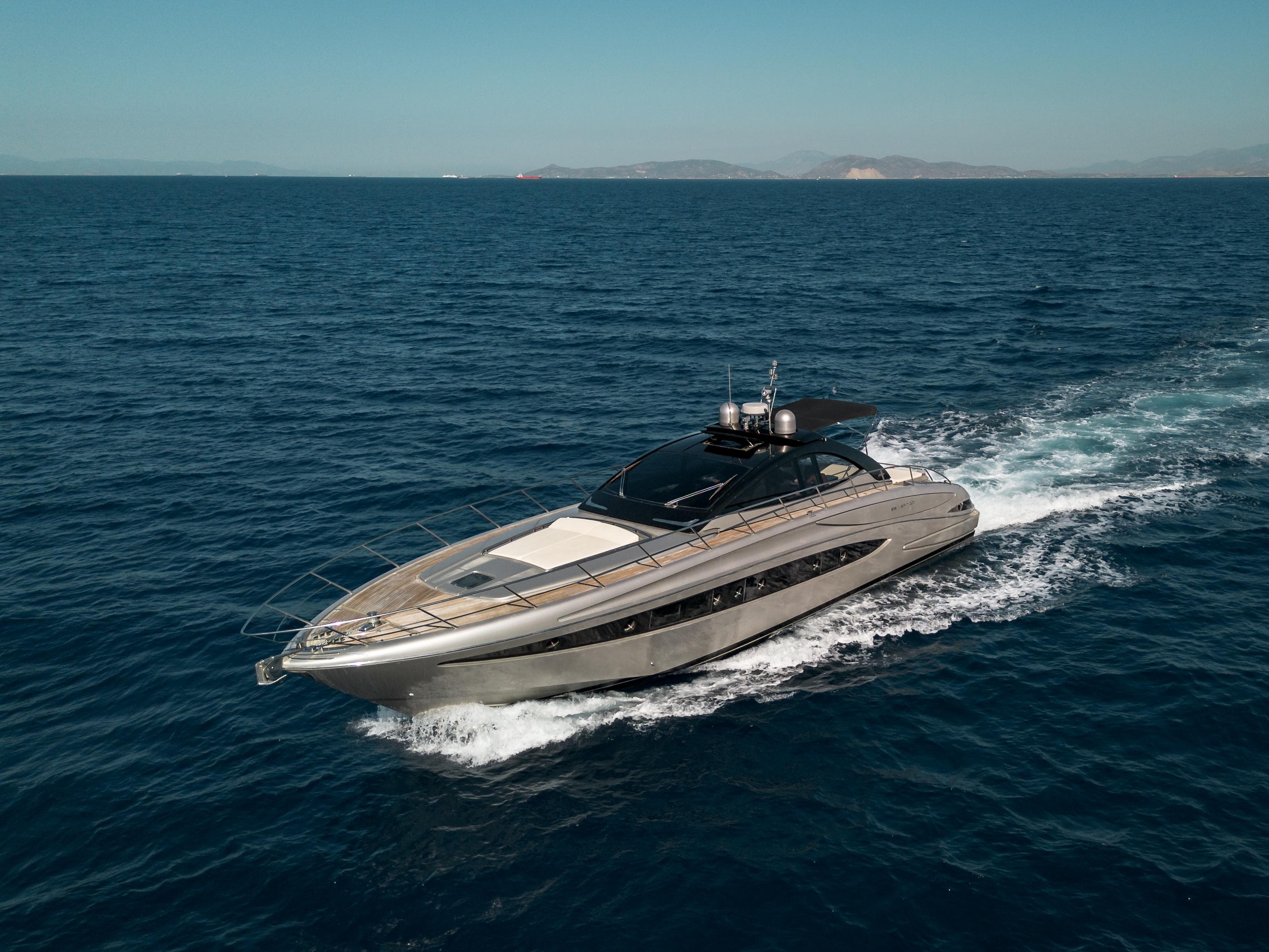 2009 Riva 63 Vertigo yacht cruising on open sea under clear sky.