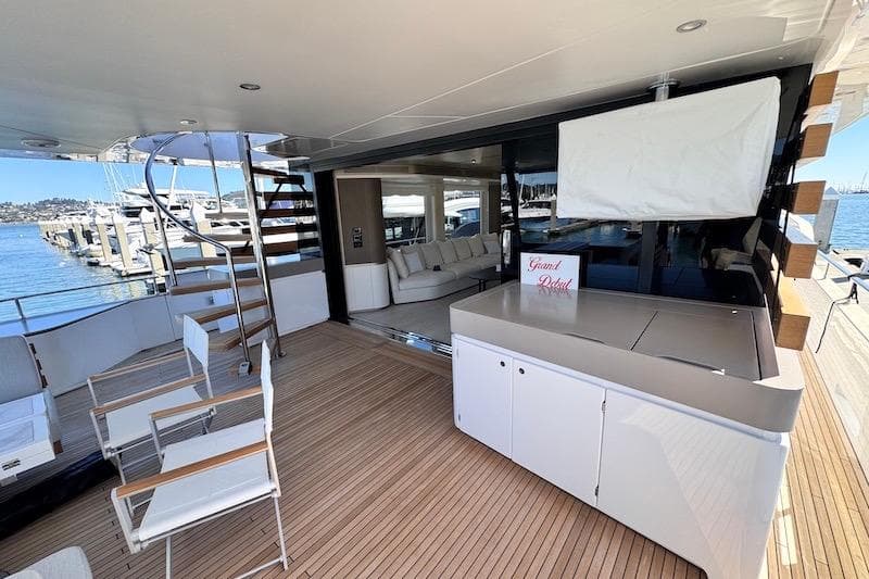 Luxurious deck of 2026 Azimut Grande Magellano 25 Metri yacht with seating and spiral staircase.