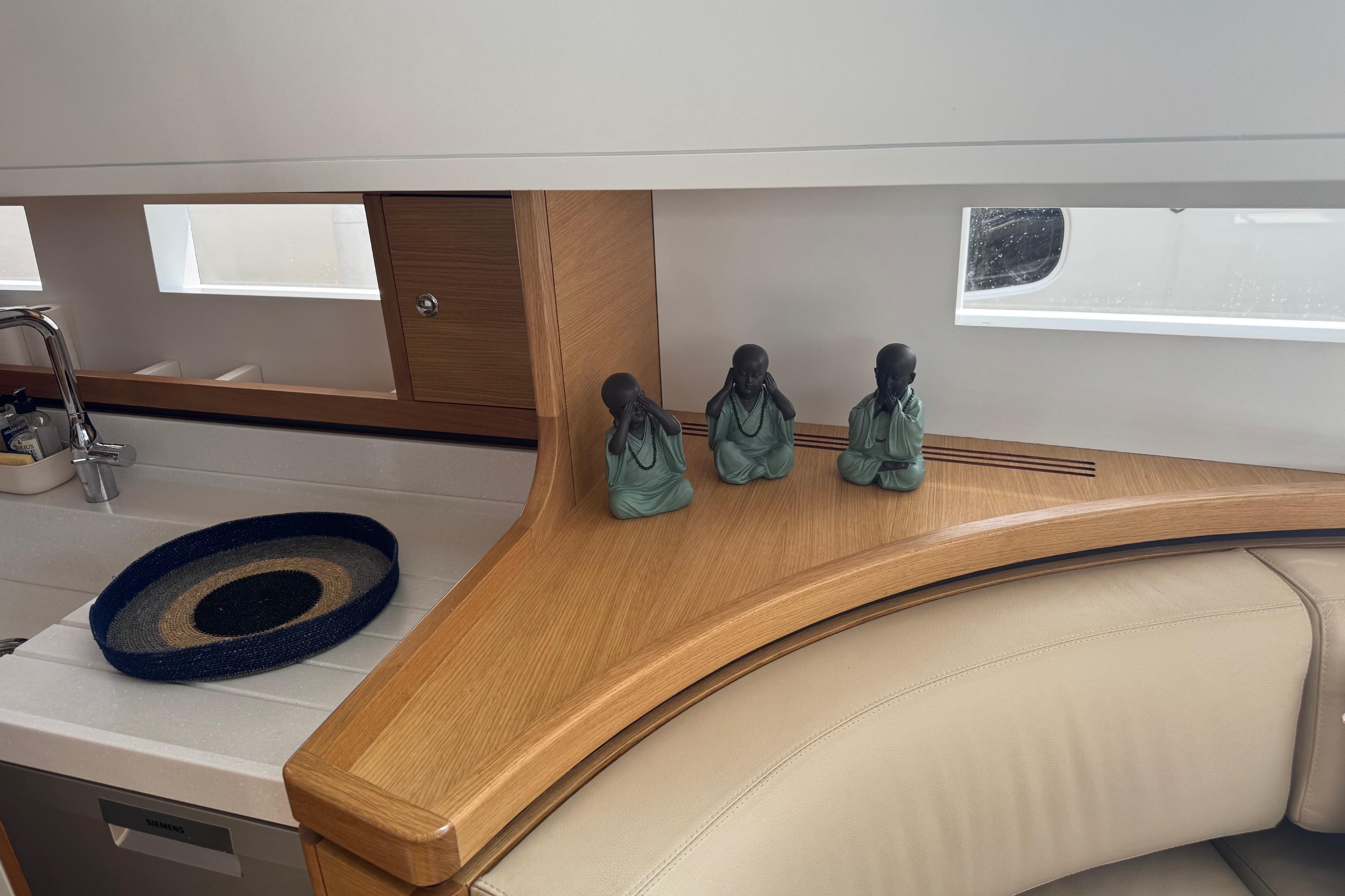 Interior of 2023 Garcia Sloop Aluminium 51 yacht with decorative statues and modern kitchen.